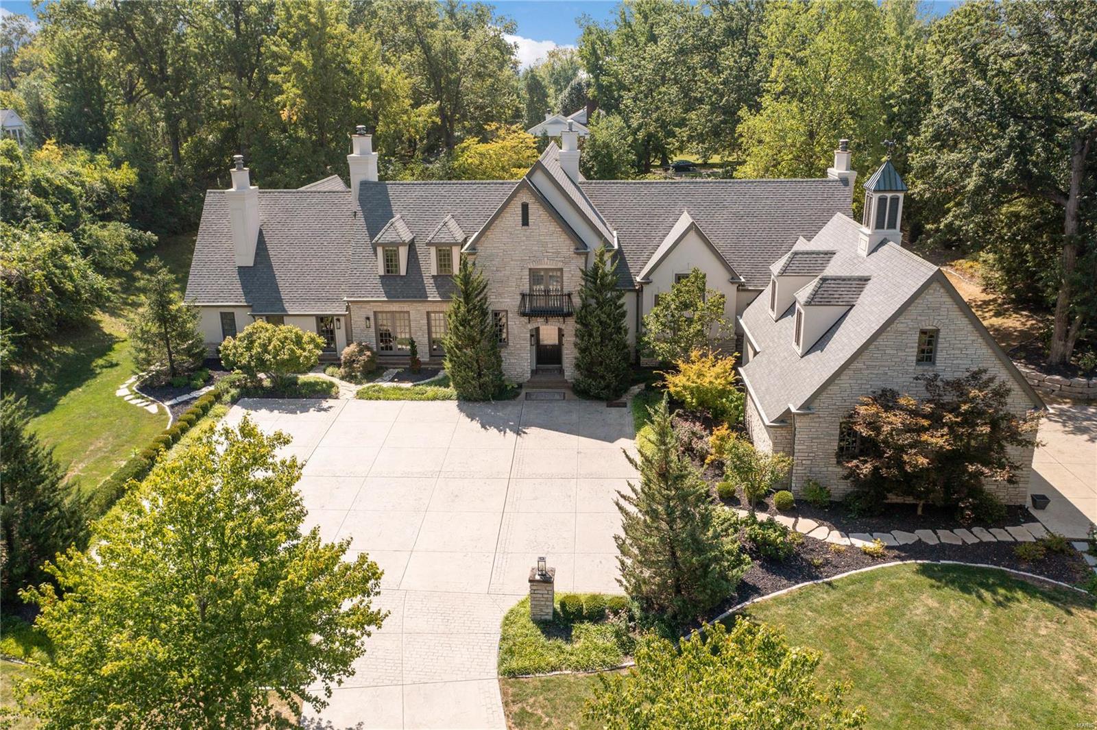 Perfectly situated on nearly 2 acres, 16 Ladue Ln is a curated, private estate with bespoke finishes & meticulous attention to detail. Thoughtfully laid out, an entertainer's dream w/ gracious Living & Dining spaces, both w/ French doors to patio. Main flr features include: Coffered ceilings, sweeping views of pool, gleaming hardwoods, designer wall coverings, Chef's kitchen w/ waterfall island, hearth rm w/ soaring 20' ceilings, 3 gas fireplaces. The luxurious main flr primary suite walks out to the patio/spa & includes spacious closets w/ private laundry, spa like bath w/ soaking tub & steam shower. Upstairs are 4 additional bedrooms, all suites! Expertly finished LL offers rec rm, bar, gym, full bath, & much storage. Step outside to the private, expansive outdoor living area, covered kitchen, fire pit, & saltwater pool- all new completed 2022!. 3 car garage. The private drive & mature landscaping complete this special property w/ so much to offer even for the most discerning buyer. Additional Rooms: Mud Room