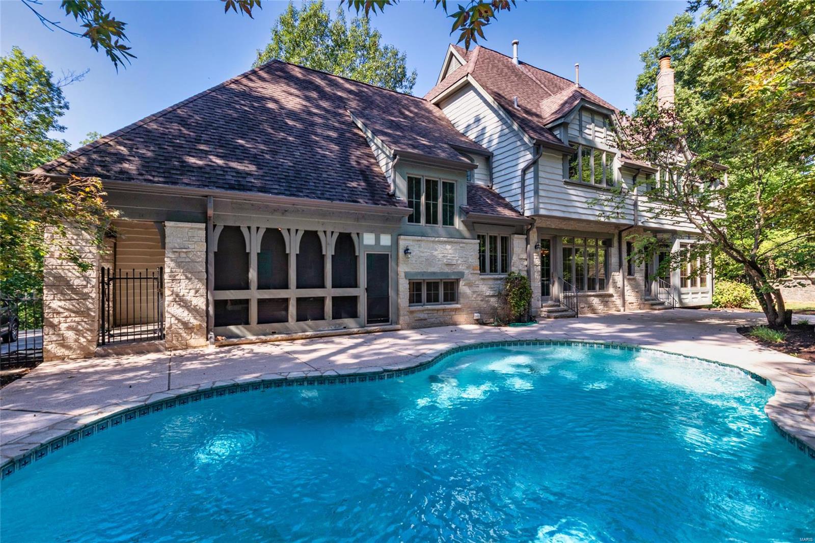 Custom stone/brick 4600+ sqft executive home on secluded 1.43 acre wooded lot w/inground pool, screen porch & sunroom. Gourmet kitchen w/large center island, Viking & SubZero appliances, granite counters & custom cabinets opens breakfast room. Great room w/cozy wood-burning, stone fireplace; wet bar, built-in bookcases. Separate formal dining room. Main floor den. Upper level game/family rm w/wet bar. 2-story, tile entry foyer winding staircase & back stairs. Screen porch off kitchen w/stone floor opens to pool. Large 16x9 main flr laundry w/storage. Owners' suite has private bath w/dual sinks, separate soaking tub/shower & deep walk-in closets. Generous-sized kids' rooms w/walk-in closets each have a private full bath. Lower level sauna, workshop/craft rm. Classic designed wood, arched doorways & coffered ceilings & front stone portico & wood flrs. New carpet. 3-car, over-sized garage. Private back patio w/stairs to terraced yard. Great value in Wildhorse Springs Farm. Rockwood. Additional Rooms: Sun Room