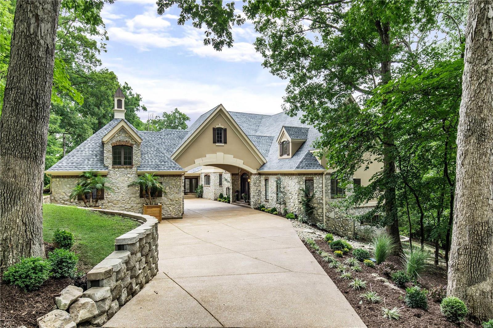 The soul of serenity, this French Country Chateau offers a sanctuary that embraces nature and is one with its beautiful private setting. From the moment you enter, the effortless open flow draws you through one fabulous space after another as every room strikes a magical balance between elegance and whimsy. Breeze through to the expansive porches that offer inspiring panoramic views of the lake. Terraced decks lead to a garden oasis, pool with fountain and spa. This entire home and property is a beautiful movie set with so many scenes for intimate moments, lavish entertaining and warm gatherings. Imagine curling up with a book or a glass of wine, delighting in all the beauty surrounding you and knowing that all of this is - yours!