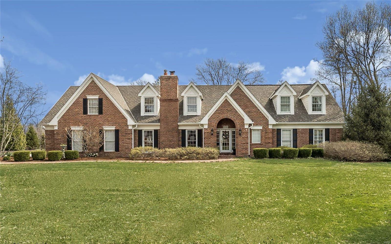 Inviting 1.5 story traditional brick home on beautiful 1 acre lot in Frontenac. This home has been extensively renovated & features 9 ft. ceilings on the 1st floor, main floor master suite with his & her walk in closets & luxury bath. Enjoy entertaining in the large family room with wet bar, custom built ins, fireplace & French doors opening to the gorgeous outside living area. The living room is highlighted by box beam ceiling, hardwood flooring, wood burning fireplace & crown molding. Separate dining room with beautiful millwork & hardwood flooring. Light filled custom kitchen with Wolf Dual Fuel gas cooktop & electric oven, warming drawer & built in microwave & wall oven, Sub-Zero fridge, granite counters & hardwood flooring. There are three spacious bedrooms and two baths on the 2nd floor. Additional features: 2 car attached, plus 2 car detached garages, zoned HVAC, lovely patio & landscaping, irrigation system, outdoor lighting & partially finished lower level with full bath.