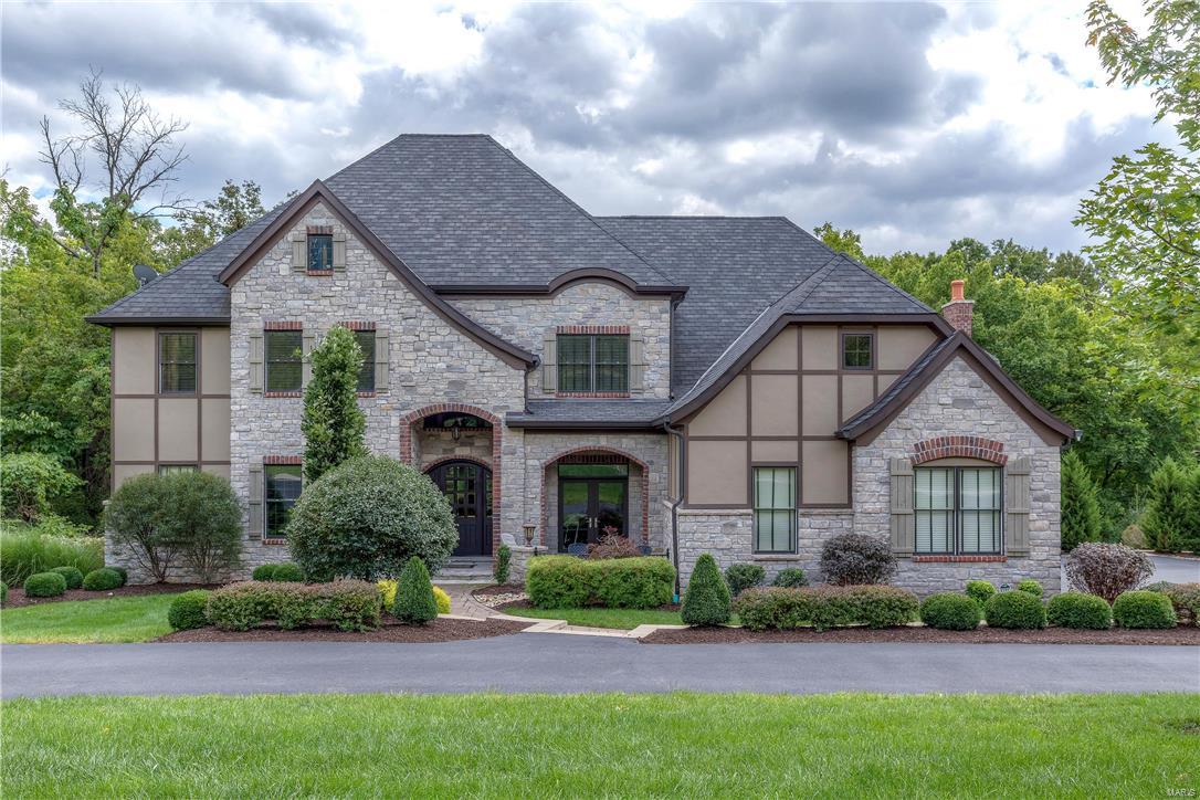 Exquisite Newer custom home on 1-acre private lot. Exceptional Exec Home with Open floor plan & uncompromised craftsmanship throughout. 1.5 story with 5 bedrooms & 6 baths. Soaring beamed ceilings, extensive custom millwork. 2 story foyer opens to study w/built ins. Private dining room has French door to patio opens to Butler's Pantry. Stunning Great room w/coffered beamed ceiling, arch stone pillars, wood flooring w/tile inlay, built ins, pass thru wet bar. State of the Art Kitchen, custom cabinets, Thermadore appliances, huge center island, sunny breakfast room, opens to vaulted hearth room w/gas FP. Coffered ceilings in Main floor master suite w/morning bar, refrigerator. Luxurious master bath with his/hers vanities, walk in closets. Upstairs has 3 bedrooms: 1 w/private bath & 2 w/Jack N' Jill baths plus a huge loft/family room. Finished walk out lower level has wine cellar, stunning bar/rec room, 5th bedroom w/private bath. 3 car garage. In the heart of Town & Country!