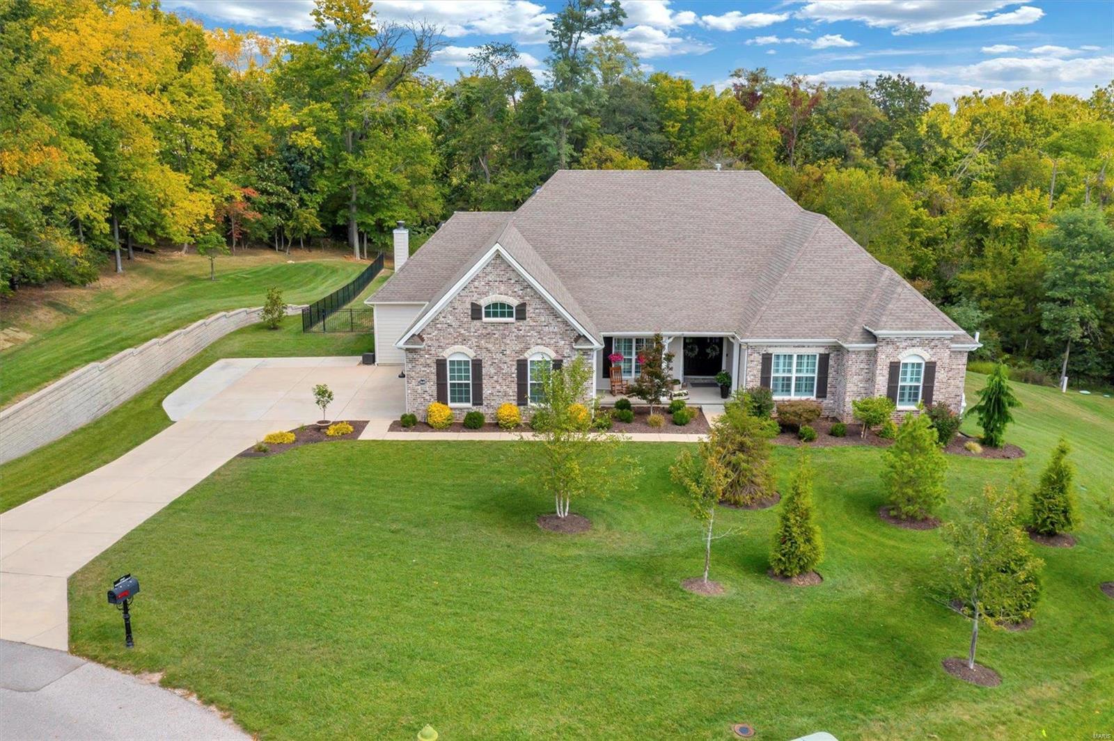Discover luxury in this custom-built Nantucket Estate in Wakefield Forest. This stunning 5-bed 5-bath home spans 4,733 sq ft on a serene 4.3-acre cul-de-sac lot, offering unparalleled privacy. The inviting covered porch opens to gleaming floors, a formal dining room, and a great room featuring custom built-ins, a window wall, and a gas fireplace. The chef’s kitchen, with top-of-the-line appliances and an oversized island, flows into the breakfast and hearth rooms with a 2nd fireplace. The primary suite boasts a frameless walk-in shower, soaking tub, and a spacious walk-in closet. Two additional bedrooms share a Jack and Jill bathroom. The full walk-out lower level includes a family room, rec room, and the potential for a 6th bedroom/bathroom. Outdoors, enjoy the private inground saltwater pool and large yard. Additional features include a 3-car garage, main floor mud/laundry room, spacious theater room, and Rockwood School District access. This home perfectly blends luxury and privacy. Additional Rooms: Mud Room