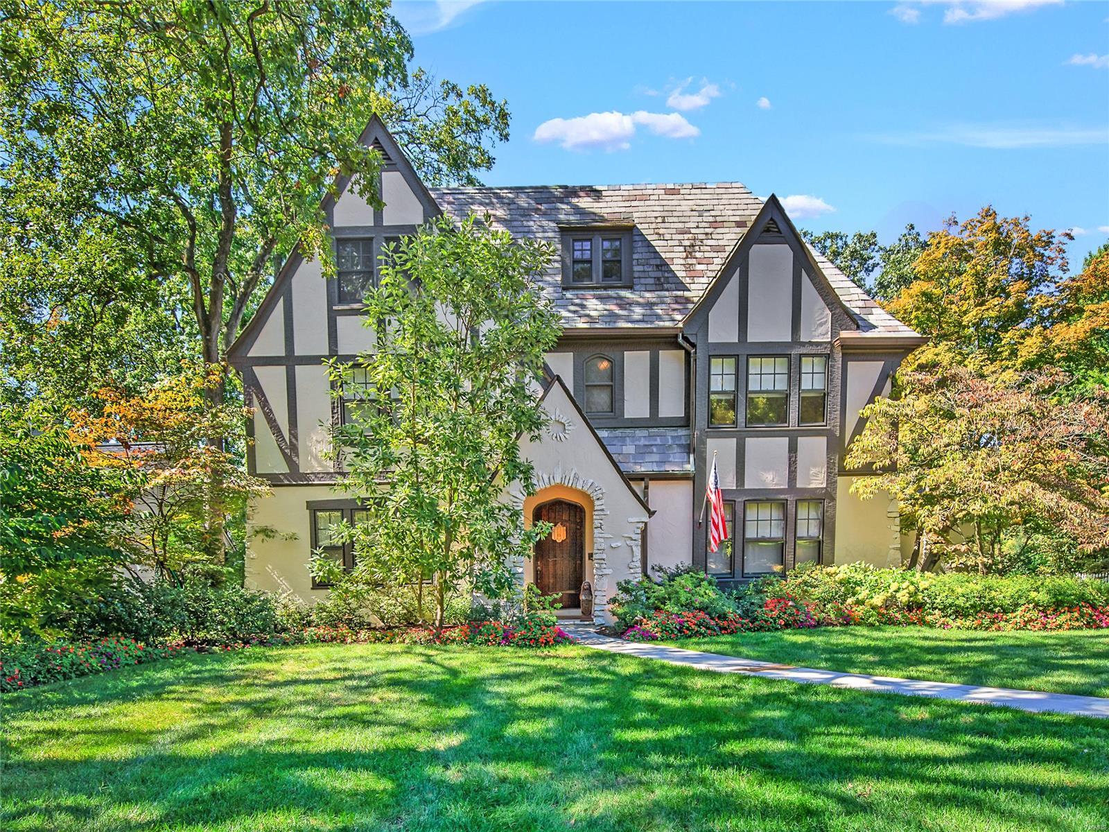 As you approach this charming Tudor home in Sherwood Forest, you feel a sense of enchantment. There are not enough words to describe the interior. This home has been tastefully & thoughtfully updated with fine finishes, blending traditional charm with a modern, chic vibe. Stepping into the foyer, you are greeted by hardwood floors & sun drenched windows that cast a soft light on the elegant living room & dining room. Chef's kitchen overlooks the step down great room with cathedral ceiling, huge windows & easy access to the outdoors. Hearth room with views of gorgeous screened porch. Butlers pantry & laundry room add convenience.  Grand staircase leads upstairs, to find a spa-like primary ensuite, well-appointed bedrooms, one ensuite, hall bath & second laundry. The custom finish third floor boasts a vaulted ceiling, bath & plenty of storage. Lush, landscaping encompasses flagstone patio creating a private sanctuary. Rare find attached two car garage. Meticulously maintained.  Special!