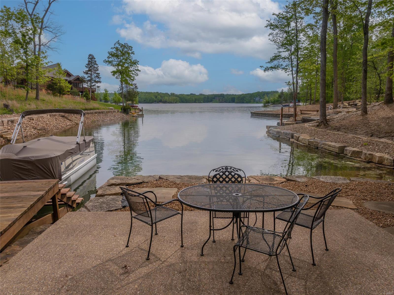 LAKE ALPINE!! Spectacular views of 236 acre lake Alpine await you. Private setting with an oasis of outdoor entertaining options. Enjoy morning coffee in the screen porch, throw a fishing line in the lake on the private dock or spend the afternoon on the private beach. Patio and fire pit area await tall tales around the campfire and smores a plenty. As you enter this custom home, you are greeted with a majestic wood beamed vaulted ceiling and a prow of windows offering panoramic views of the lake. A Chefs delight kitchen offers solid surface counters, island breakfast bar, plenty of custom cabinetry and work space, walk-in pantry, private dining room and screen porch leading to a spacious deck. ML bedroom/bath w/ den/office. LL walk out offers 2 additional bedrooms and 2 baths, game room, living room with built in cabinetry and wet bar. 3 car attached garage w/ additional loft storage. Most furniture included. Lot next door, 2374 Alpine Oaks available as well, shared pond and bridge