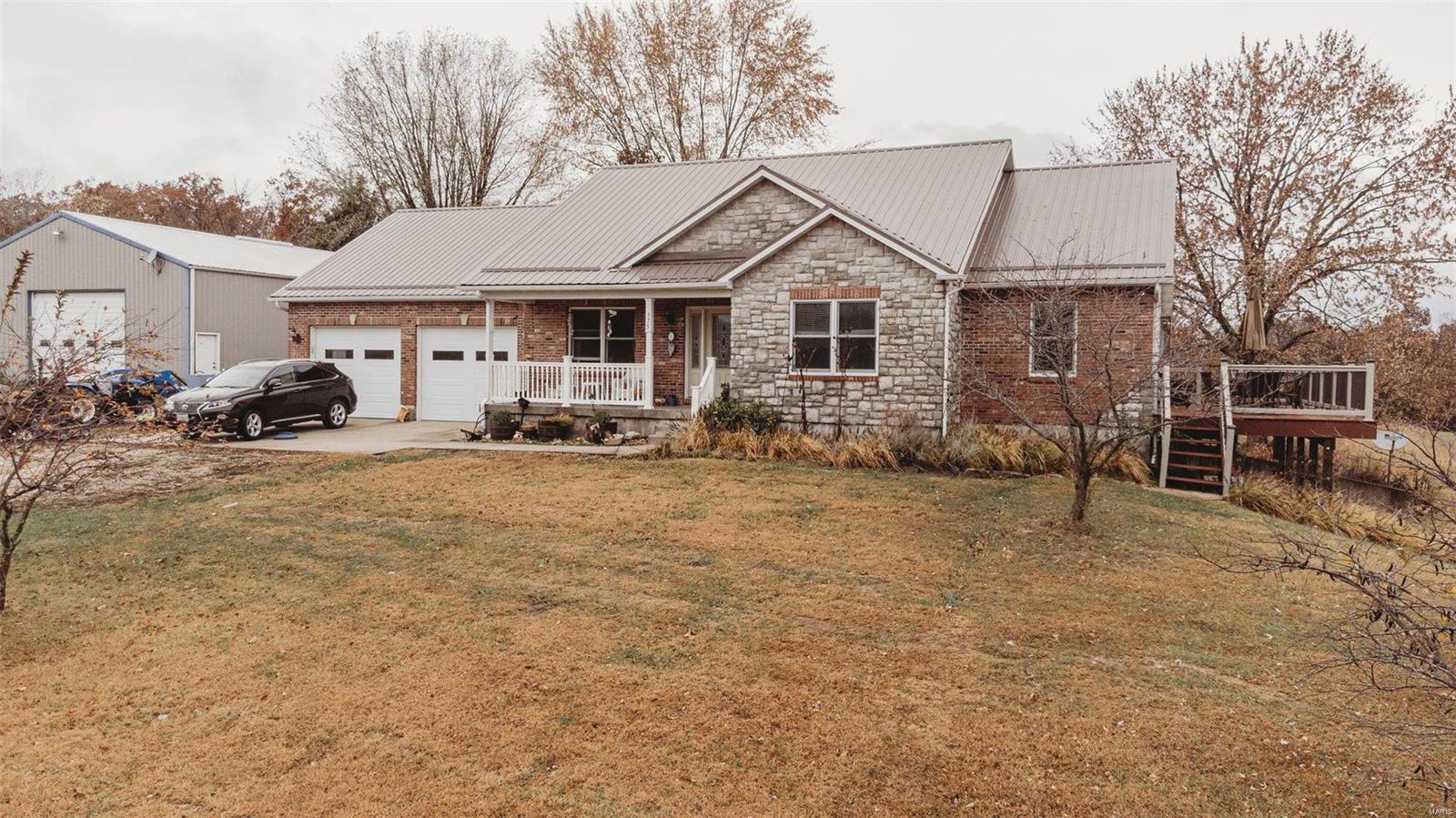 Looking for a quite getaway? Come, see and listen! This home built in 2007 has 3 bedrooms and 2 baths on main floor with ~3600 sqft of living. Additional bedroom and bathroom in basement that has 9' ceilings with additional storage space and plenty of room to grow. The home is surrounded by ~161 acres of pasture and woods for plenty of scenic view evenings on the 30x12 patio. Basement includes storm room with steel door for those ominous nights of weather. For those looking for hunting or farming possibilities this would be a great place to start a small heard of cattle or have a few horses or both!Large hay barn built in 2015 for your tractors and hay.40x60 utility shop on property as well. Pasture has waters already for cattle or horses. Large utility room and oversized 2 car attached garage.