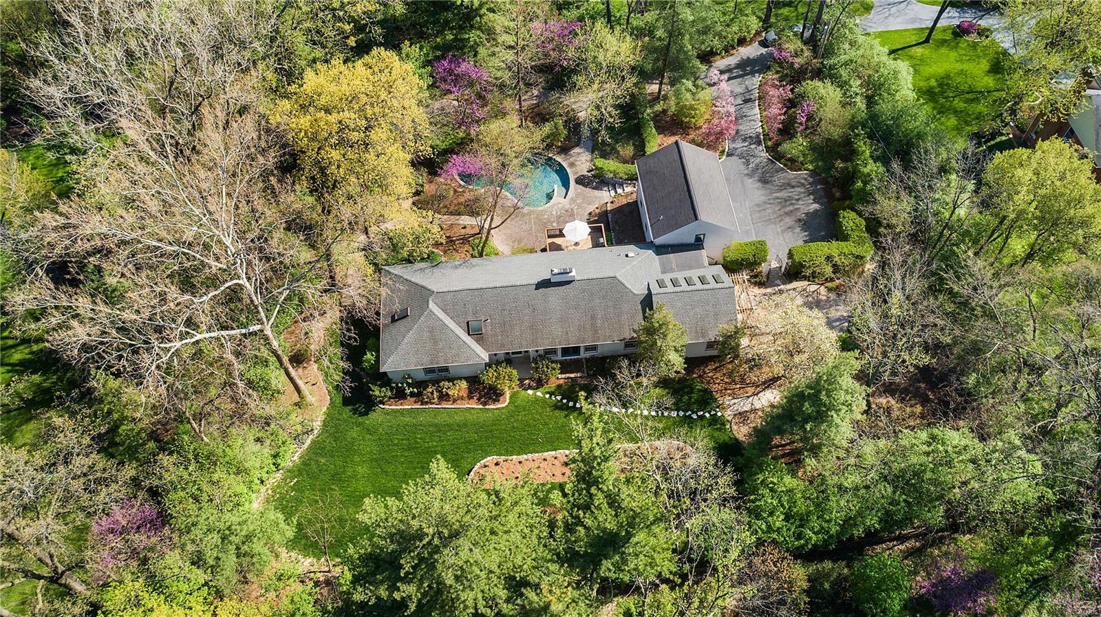 Paradise found. Perched in the middle of an idyllic 1.2-acre property, in the heart of Frontenac sits a light, bright and welcoming abode w/over 5000 TLA that boasts inspiring views from every room of mature trees & flowering perennial paths. Artfully transformed you’ll love all the new flooring, fresh color palette & attractive designer light fixtures throughout. Whip up your favorite meals in expanded chef's kitchen w/huge island, glass-front cabinets, pretty quartz counters, farmhouse sink, copper fixtures & hearth room w/see-thru fireplace. Enchanting gathering places flow from pergola entrance to vaulted/sky-lighted great room to tasteful DR & casually elegant LR. Admire 5 spacious bedrooms (2 private en-suites, one previously an art studio) & 5 stunningly renovated spa baths. Take advantage of the reconfigured walk-out LL (with rec room/bed/bath/office), gorgeous salt-water pool & plenty of outdoor getaway spaces for all your entertaining and relaxing needs. It's good to be home! Additional Rooms: Mud Room