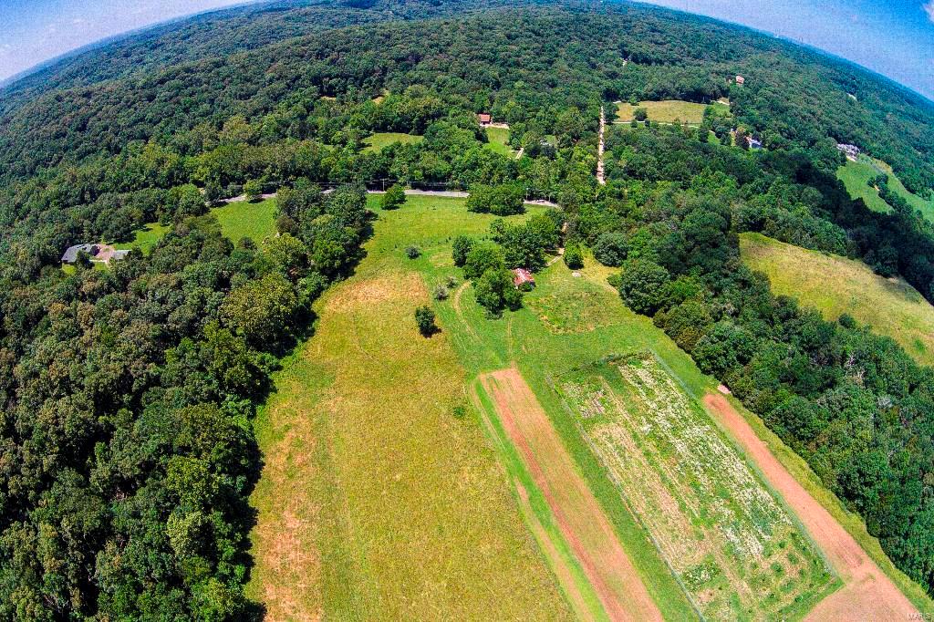 Crave Privacy??? Get away from it all on your own private pristine 80 acre estate! Got Horses? Fantastic 80 acres & bordered on 2 sides (North & East) by Rockwoods Range & access to Greensfelder give privacy & access! * You could ride forever! Want to build your own dream home? Rare opportunity to own one of the last big gorgeous private parcels in Wildwood! Western portion of St. Louis Co.West of 109 & between 100 & 44! ! Could also be subdivided into 3 acre lots! Zoned NU: Non-Urban. Minimum 3 acre lots. Max yield 26 lots per Wildwood. Gently rolling to sloping topography.  Majority rolling terrain.  40%-50% is cleared. Remainder wooded.  Site contains  1 shed, well, septic, cisterns. Electricity on property. Registered small Schlemper Cave.Phase 1 & Geotechnical Report from 2006 available. Don’t miss fantastic opportunity! 4452 & 4376 Fox Creek tied to 27Y-24-0023