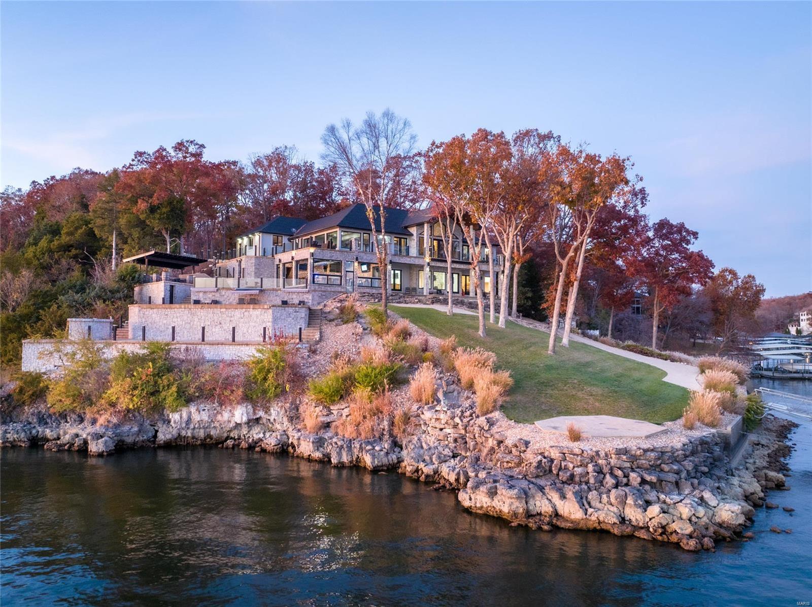 Point estates are very special, impossible to duplicate and rarely have moderate topography that doesn't require a steep drive or compromise access to the shoreline and your 5 slip dock! Welcoming and refreshing this home epitomizes lakefront living, offering a custom pool, hot tub, helipad, heated/cooled indoor bar with chef kitchen with roll up doors to bring the outdoor into your day. The views to the east and west are one of a kind and shown off from nearly every room in the house. Come enjoy the Midwest Coast on the beautiful Lake of the Ozarks, where we have a lifestyle for you. Additional Rooms: Sun Room