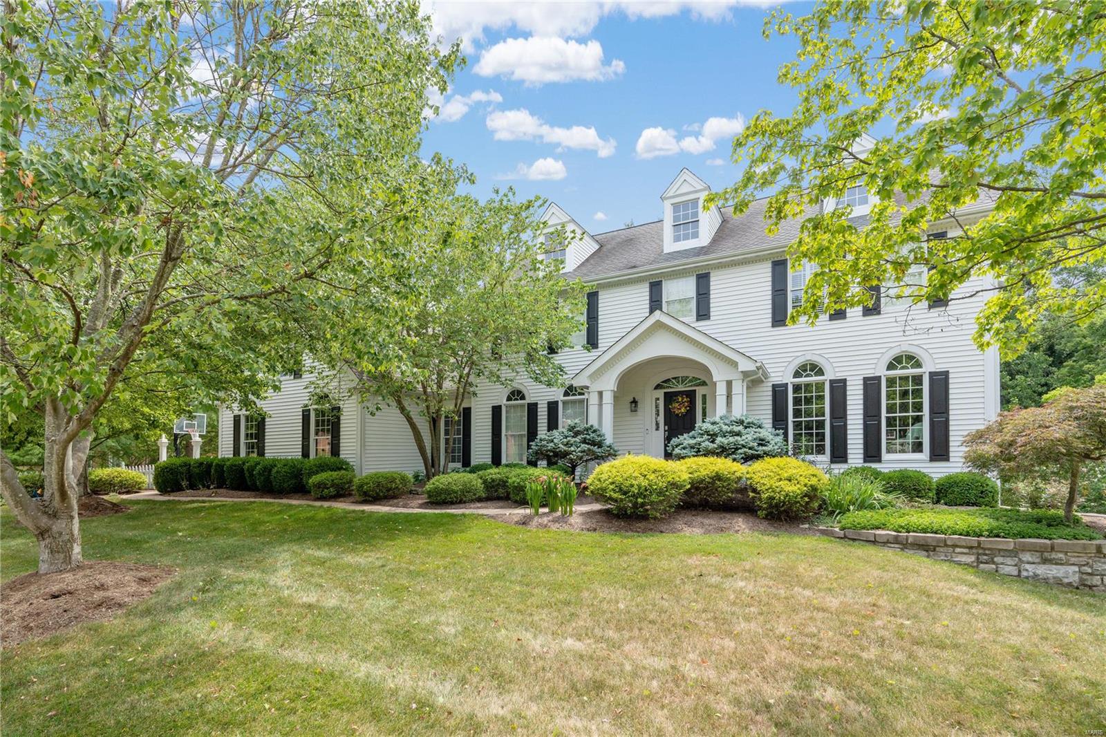 Chic and Updated 2-story nestled in an ultra private park-like setting in the sophisticated Wilson Manor Neighborhood. Main floor boasts bright spacious rooms, a neutral palette, sleek hardwood floors, & large windows. Expansive Family Room seamlessly connects to the the Fully Loaded Cook's Kitchen featuring; breakfast nook, center island, granite countertops, coffee bar & French doors leading to cozy screened-in porch with views of the private and lush backyard. Main floor laundry/mud room just off 3-car garage. Second floor offers tremendous space w/ 4 bedrooms & 3 FULL UPDATED bathrooms, including the bright & airy primary suite w/ spa-like bathroom & walk in closet. UPSCALE Lower level walk-out has it ALL with rec/family room, full bar, full bathroom & 5th bedroom. Walk-out to your covered patio with a hot-tub & peaceful surroundings. You will LOVE the sprawling deck with incredible green space, extensive landscaping & spectacular mature trees. Award Winning Schools & Location!