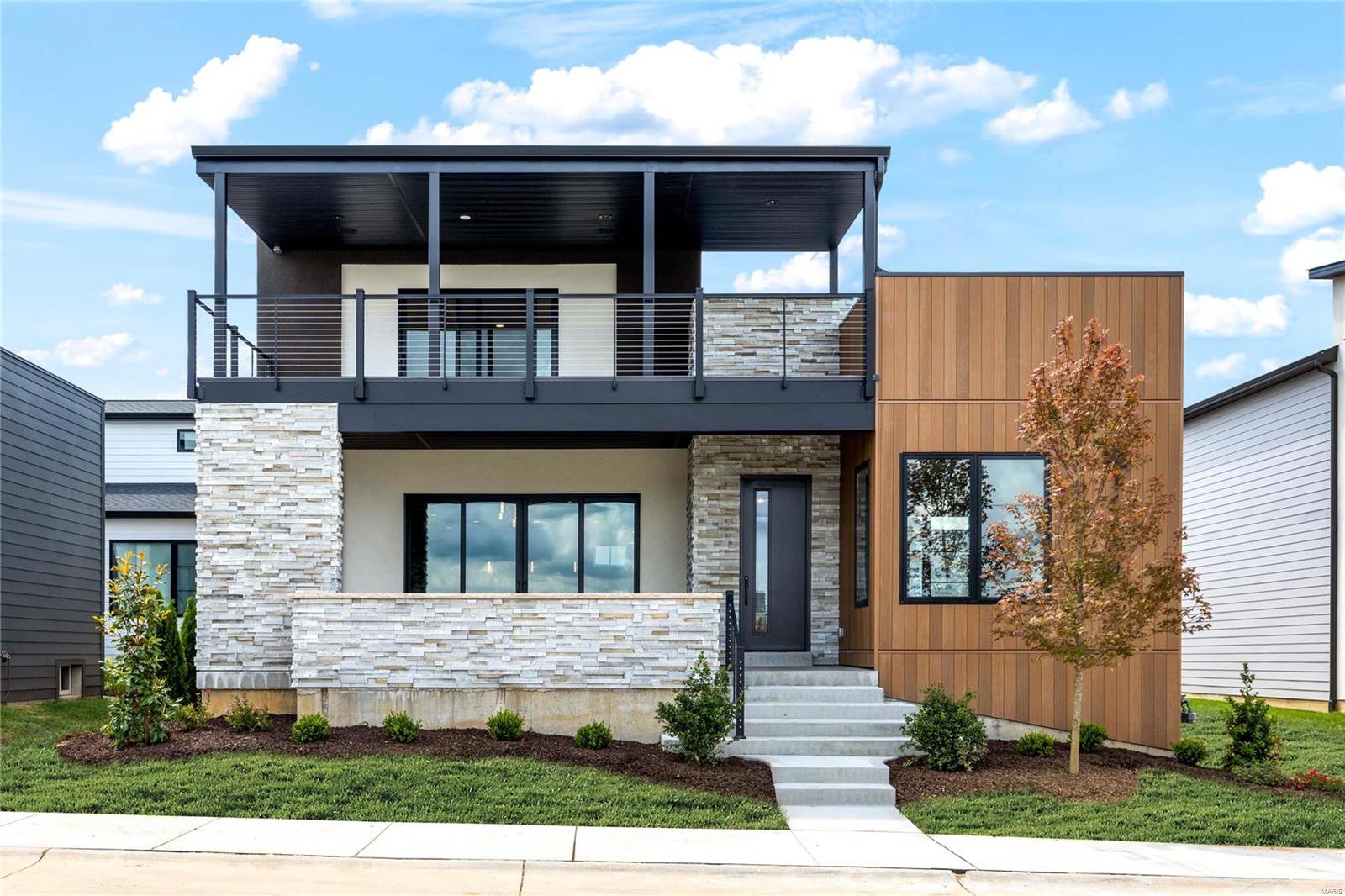 New construction in Chesterfield’s prestigious Waterfront at Wildhorse Village. With approximately $1,000,000 in builder upgrades, this sophisticated Contemporary redefines luxury living. Open floor plan features 10’ ceilings, wide plank flooring, designer lighting & expansive windows that offer perfect views of the community lake. Inviting lanai leads to impressive entry foyer, private study, stunning great room highlighted by floor-to-ceiling linear fireplace, adjacent dining room & state-of-the-art kitchen with quartzite countertops, commercial grade appliances & 10’ center island with waterfall edges. Spacious primary bedroom suite with spa-like bath provides an appealing retreat. The 2nd floor extends the living quarters with a 2nd ensuite bedroom plus 2 additional bedrooms, hall full bath & bonus room that walks out to covered deck. Lower Level includes recreation room, 2nd kitchen, 5th bedroom & full bath. Premium waterfront lot with private outdoor living areas & 3-car garage.