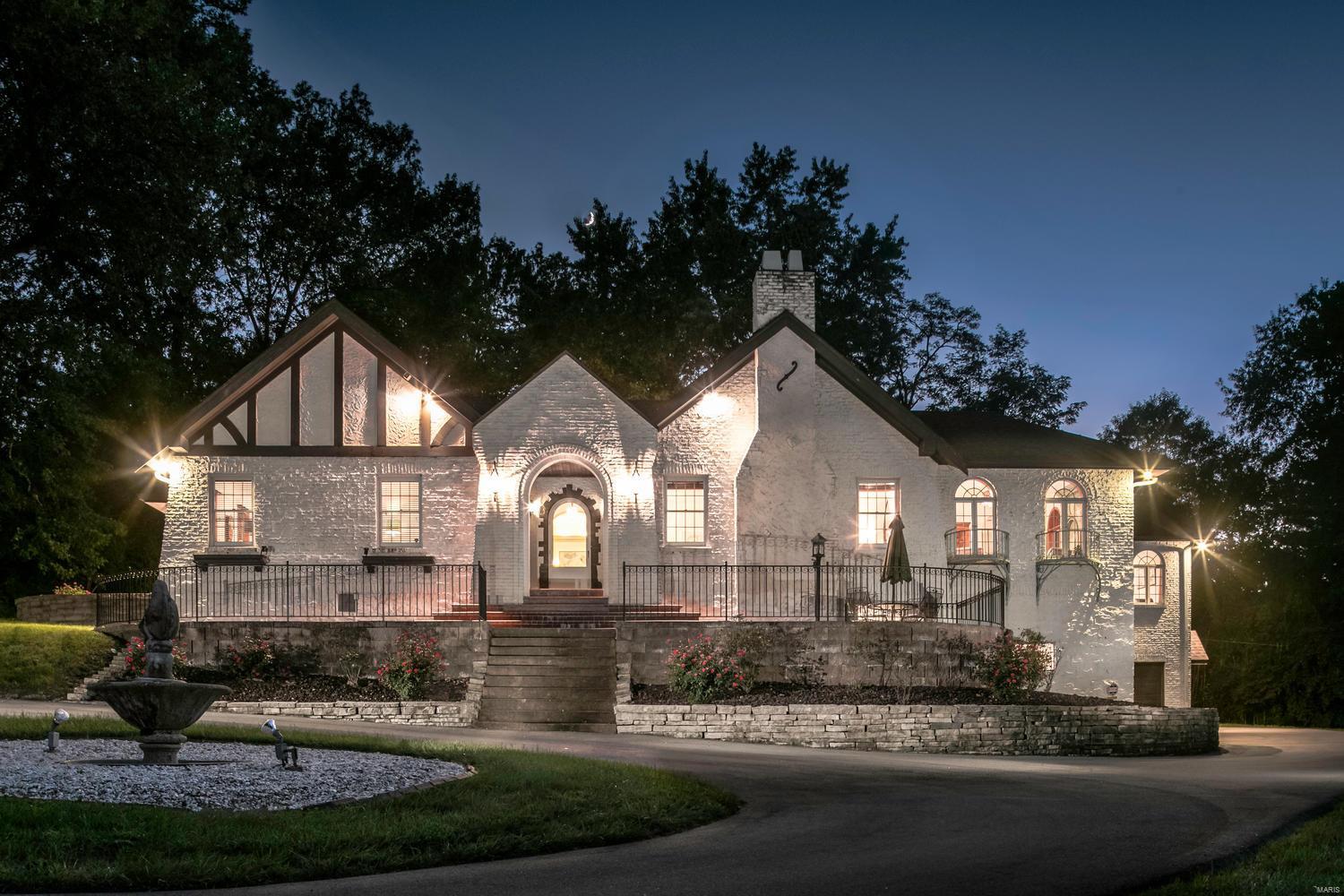 A Frontenac Oasis with Dramatic Spaces! One of the Most Interesting Architectural Homes on the Market!  4 Bedrooms, 3 Full & 2 Half Baths.  Nearly 3 Acres of Mature Trees, Lush Grounds with a Tennis Court. Terrazzo Floors, Decorative Moldings, Palladium Windows, Art Nouveau Sconces, Decorative Ironwork are Some of the Special Features Found in the Home.  The Grand Room Features a 14’ Coved Lit Ceiling & a 6’ Wood burning Fireplace.  French Doors Lead to Light Filled Red Oak Paneled Vaulted Great Room w Dentil Molding w Wet Bar & Access to Private Patio.  Relax in ‘The Sanctuary’ A Lovely Space w Ornate Imported Italian Tile Fountain as the Focal Point.  Eat in Kitchen has an Attached Breakfast Room w Bay Window, Custom Pantry w Pull Out Shelving & Butler’s Pantry. Great for Entertaining! Luxury Master Suite w/ Custom Closets, His/Her Vanities & Commodes, Separate Soaking Tub & Shower.  Main Floor Laundry.  Basement w Incredible Amounts of Storage, Exercise Area & 4 Car Garage. Additional Rooms: Sun Room