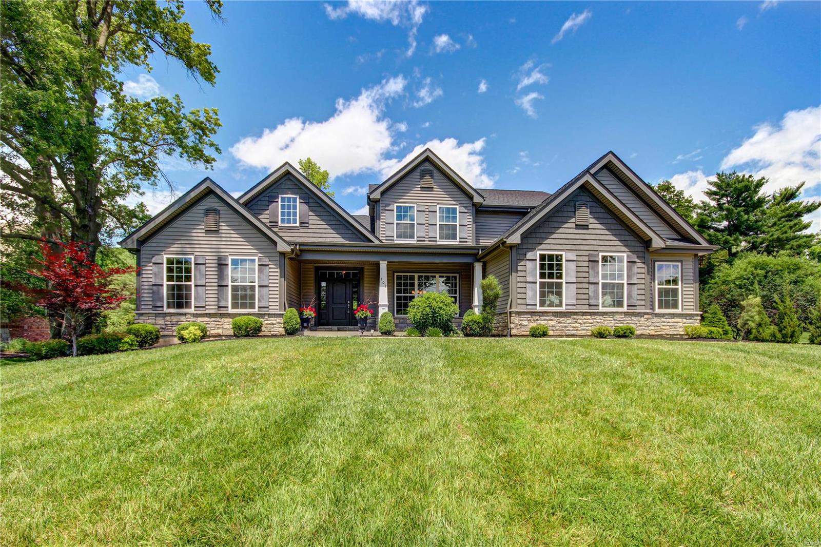 Welcome to this stunning custom 1.5 story, built in 2017 in an established Creve Coeur neighborhood. This home is immaculate down to the last detail: hardwoods, tray ceilings, stylish lighting, millwork and crown molding throughout! You'll be wowed by the craftsman exterior w/stone accents and 3-car side-entry garage. The main flr features a lovely dining rm, French doors leading to the office, and living rm w/gas fireplace. The gem of the home is the modern farmhouse kitchen, boasting stylish two-tone cabinets w/organizers, granite counters, high-end Jenn-Air appliances, tile backsplash, and a view into the vaulted hearth rm with floor-to-ceiling stone fireplace, and butler's pantry w/wet bar and wine cooler. The master suite is a dream w/dual walk-in closets w/organizers, freestanding tub, step-in shower and dual sinks. Upstairs are 3 bedrms and 2 bathrms. LL has tons of room for storage! On nearly an acre, moments from Bellerive Country Club, this magnificent home is ready for you!