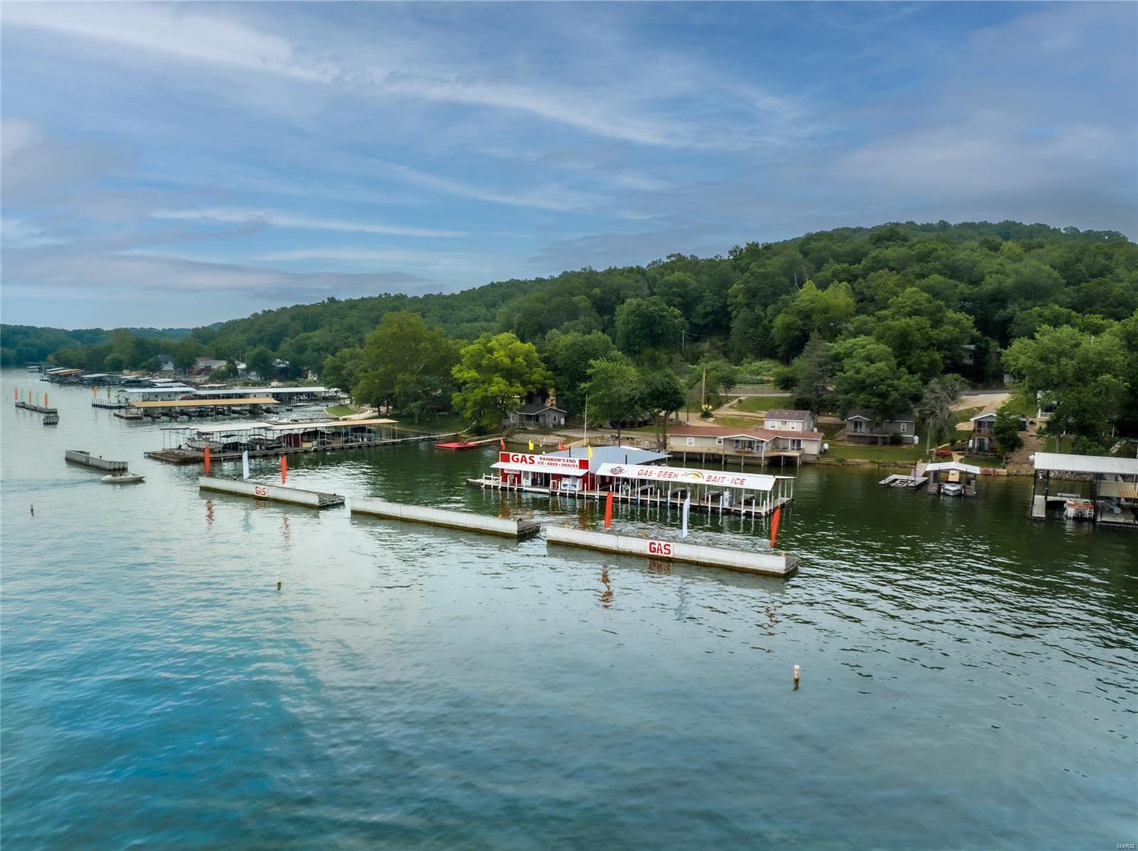 MUST have an appt as this is an active business. Fantastic opportunity to own a profitable & popular marina & resort on the Lake of the Ozarks in a PRIME location by water at the intersection of the Big and Little Niangua! The marina is largely protected by 3 massive wave breaks (huge bonus for gas customers) and comes equipped with a c-store, 10 boat slips, 3 jet ski lifts & 2 jet ski fueling ports. A 4000 gallon, dual wall flameshield tank feeds three dual-sided pumps along 125 feet of dock allowing service for up to 7 watercraft at a time. The resort area features 6 lakefront cabins and amazing views along 268 ft of shoreline, boat ramp, private swim deck and huge martini deck for guests. 4 cabins are 2bed/1bth and can sleep 4-6 guests, 1 cabin is a 1bed/1bth currently used for dock operations but could be rented. The 2bed/2bth owner's house is uniquely positioned at the waters edge with a large private deck and 2-car garage. Already profitable, there's HUGE upside potential! Location: Rural