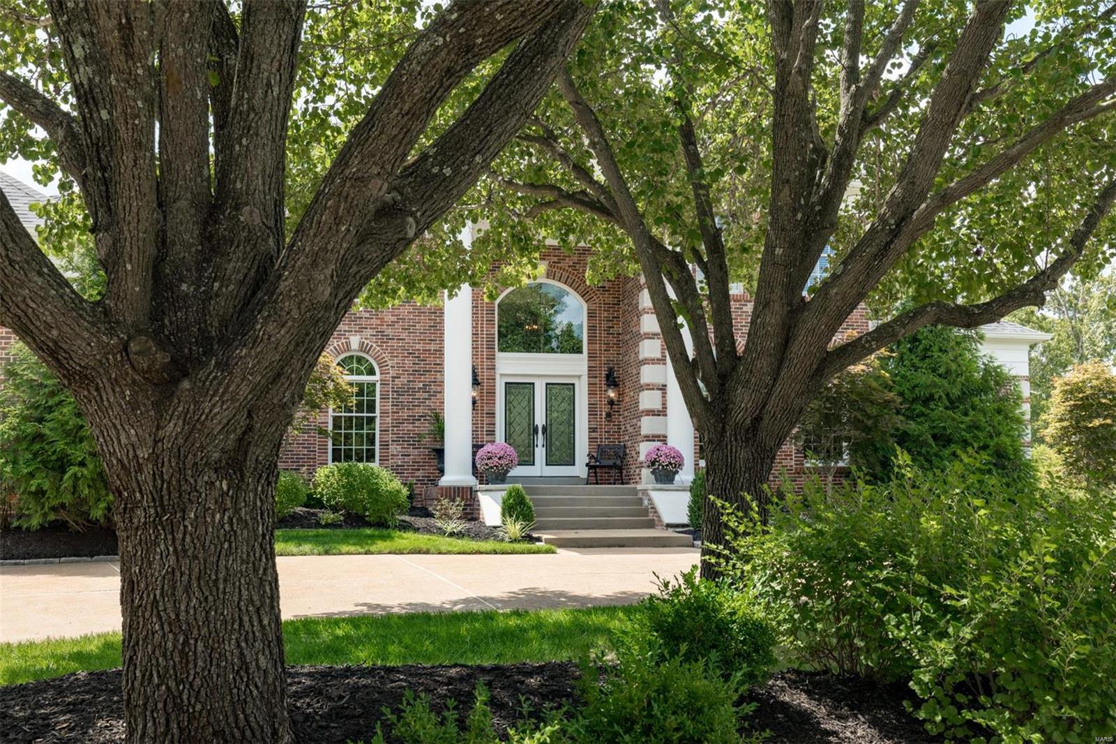Enveloped by nature yet centrally located makes this stunning home a rare find! The circle drive and lush landscaping welcome you while soaring ceilings, gleaming wood floors and light filled rooms beckon you inside. A two story fireplace is the focal point of the great room which flows into kitchen with a pantry that will satisfy your inner organizer! The wood paneled den with custom bookcases and glass doors opens to the spacious 1st floor master suite that’s complete with luxurious bathroom, coffee bar and two walk-in closets. Ascend the open dual-staircase to find a loft, 3 additional bedrooms and 2 full baths. The walkout lower level offers huge rec room spaces and a spectacular wine room that features reclaimed materials from historic STL!. A truly serene backyard with flagstone patio, fire pit and bistro lights create your own nature oasis for relaxing under the stars. Bellerive Country Club is just a golf cart ride away. Convenient to highways, hospitals and schools. Additional Rooms: Mud Room