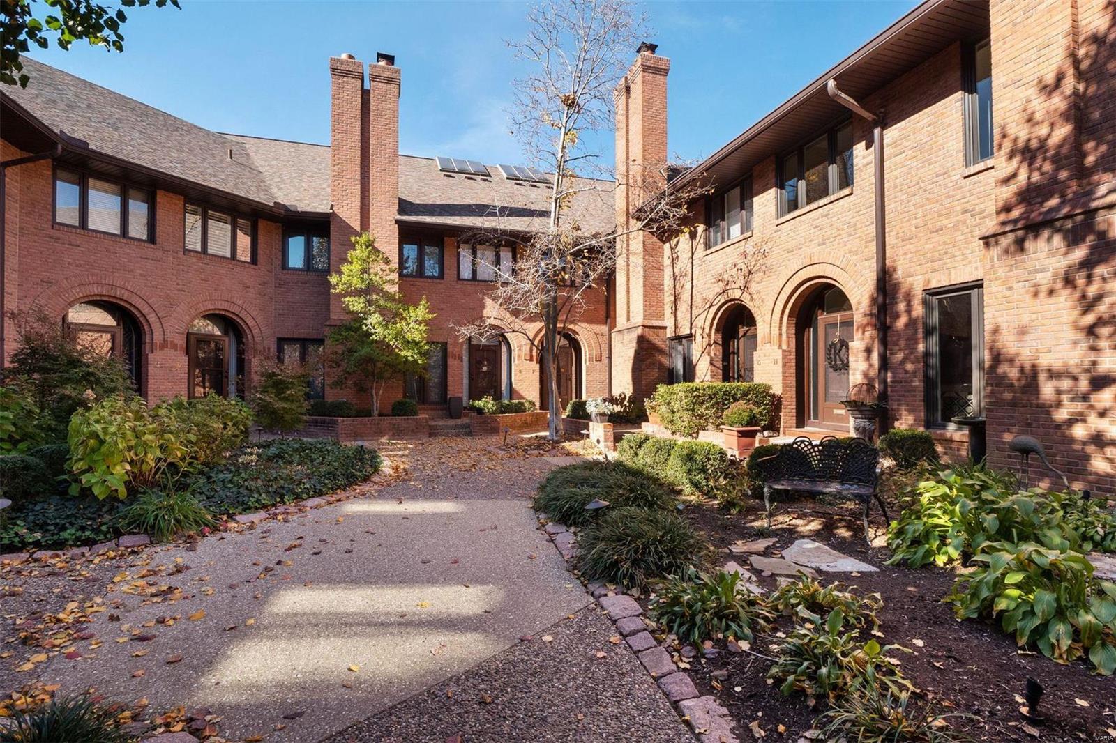 Indulge in urban luxury at the doorstep of downtown Clayton with this contemporary townhome. With an air of sophistication that's sure to impress your guests, the main level's open floor plan is designed to make entertaining a pleasure. The sunlit Living Room features a gas fireplace flanked by floor-to-ceiling windows. The glamorous Kitchen is equipped with top-tier appliances, while the  Dining Room, complemented by a wall of windows with a sliding glass door, invites you to the private, enclosed patio retreat. New engineered wood flooring throughout the main level. The soaring ceiling and monumental arched window of the 2nd floor Primary Suite are show stoppers, and the adjoining Bath rivals the finest spas. 2nd floor Laundry. 2 additional Bedrooms are ensuite. The LL includes a Family Room, updated full Bathroom, huge storage room, and direct access to the shared garage. In-unit elevator services all three floors. Location: Corner Location, End Unit, Ground Level, Suburban