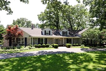 Welcome to this well appointed and updated home in Ladue.  This classic 1/12 story has a main floor en suite master bedroom with whirlpool tub and separate shower. Upstairs are 4 additional bedrooms and 2 baths.  The main floor has an updated kitchen with granite countertops opening to a hearth room with an inviting  fireplace, hardwood floors and extensive moldings. French doors open to the large deck overlooking the propery. There is a large wood paneled family room with an additional fireplace, wet bar and built-in bookshelves, perfect for entertaining!.  The lower level has a handsome stone fireplace in the finished family area, full bath and walk-out to the in-ground pool and gardens. One can enjoy the pool and gardens from the first floor deck as well, while overlooking this serene and private landscaping in the heart of Ladue!  You don't want to miss this wonderful, spacious and gracious home!