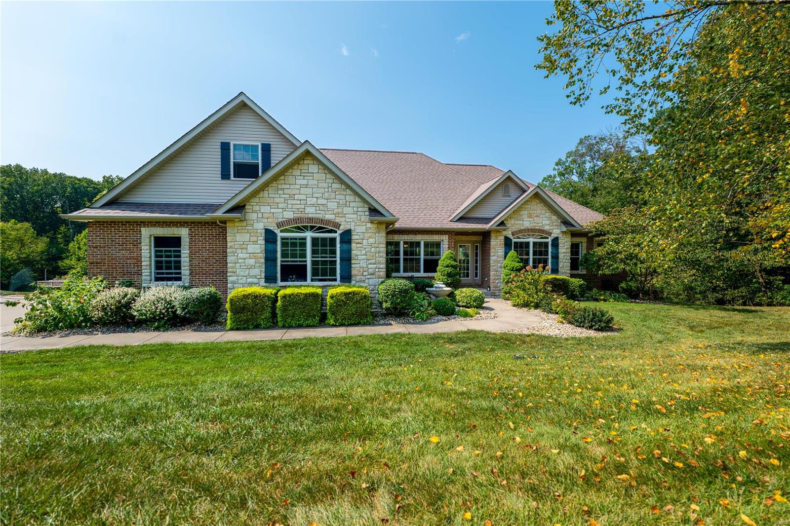 HERE IS EVERYTHING YOU WANTED IN A HOME! Fantastic renovation to the main level. Over 4000+ total SQFT with a covered deck overlooking the pond and woods. Beautiful outdoor entertaining space, stocked lake with a dock. Features of the home include 4 BR, 3.5 BTH, vaulted great room w/FP, & new Hickory floors throughout the main floor. The professional kitchen is sure to impress with a Wolf range & large prep space opening up to the living area which leads to the covered deck. The bar area in the LL is set up for parties near the theater room where you can watch the big game through surround sound speakers. A 2-car attached garage is complemented with a 3-car detached 30x50 garage w/concrete floors, electric, HVAC, bathroom, & 2 horse stalls. The 50x50 metal outbuilding is built for your RV or workshop and has 14' doors, plus reinforced concrete floors. 15KW Solar system to keep your energy bills ultra low! New roof and all of this on over 10 acres. What a fantastic place to call home!