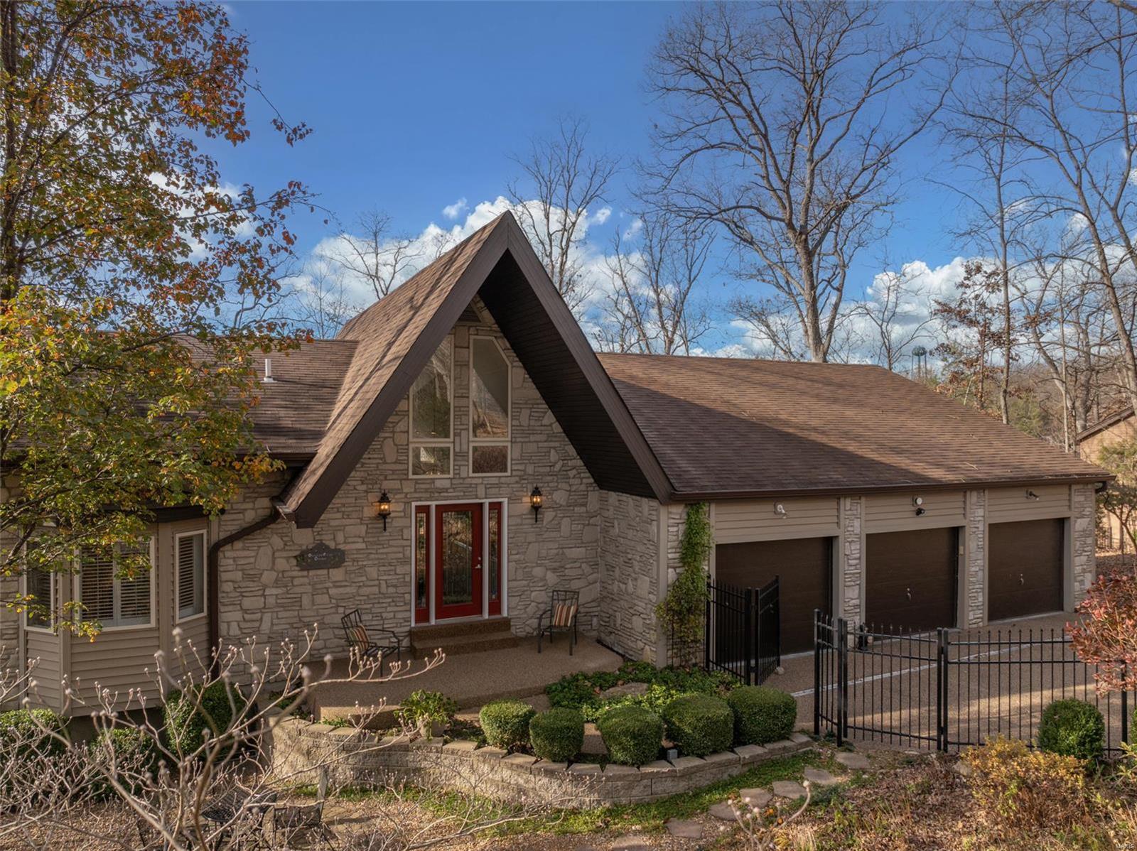 This welcoming lakefront home embodies cozy charm. Nestled on a gently sloped wooded lot, this property boasts serene waterfront views and many thoughtful features. Step inside to find a vaulted living room adorned with a stunning stone fireplace. The spacious main floor is anchored by a primary bedroom suite and a delightful all seasons room. The large kitchen is a chef’s dream, featuring a massive center island, ample cabinetry, and plenty of room for entertaining. The lower level has 3 additional bedrooms plus a rec room. Outside, there's an oversized three-car garage plus a fenced in front yard showcasing a breathtaking Missouri perennial flower garden, complete with a large koi pond and a cascading waterfall. A sprawling deck creates an ideal space for outdoor gatherings. At the water’s edge, a fantastic lakeside dock awaits—perfect for boating, fishing, or soaking up the sun. This lakeside haven is more than a home; it’s a lifestyle. Agent is related to seller. Additional Rooms: Sun Room