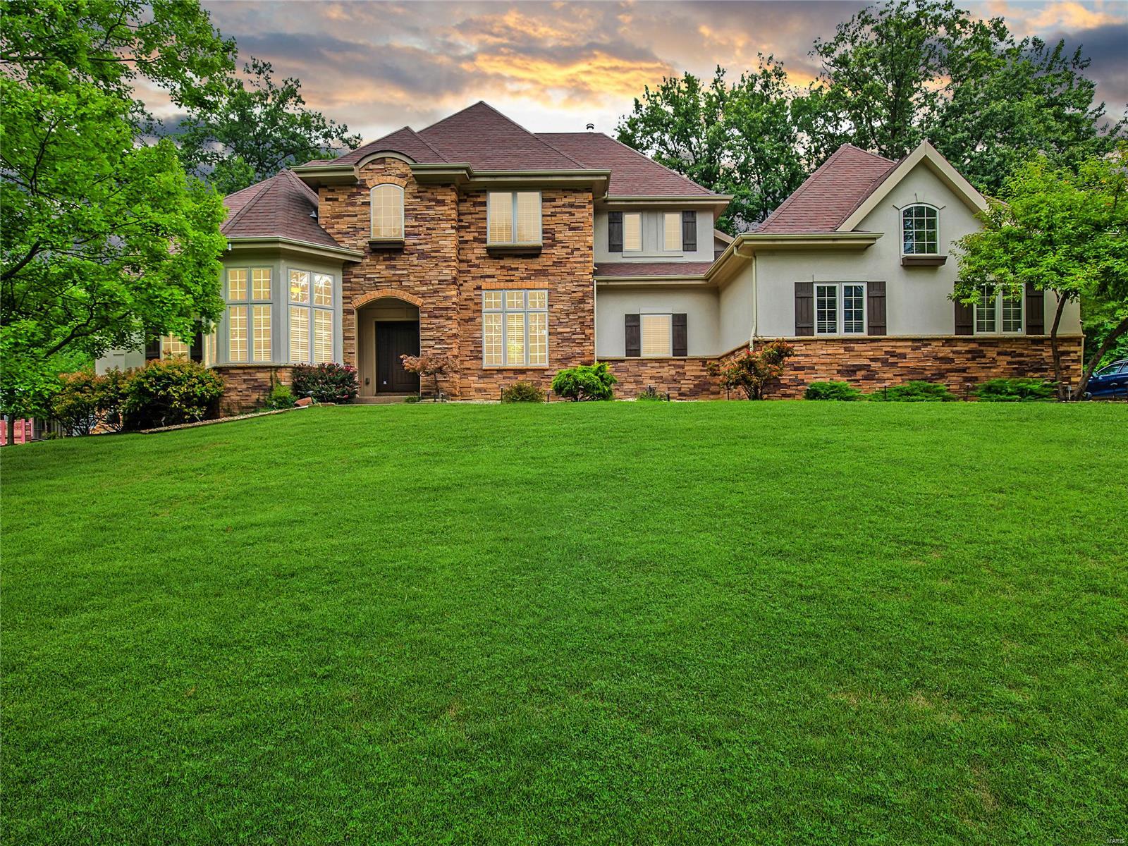 Welcome to your Distinctive Collection Manlin Built home in Ladue. The main floor offers vaulted ceilings and beautiful wood flooring throughout the open floor plan. Large windows let in loads of natural light. Beautiful eat-in kitchen with white cabinetry, granite countertops, 6 burner gas range, pot filler and 2 pantries. Main floor Primary suite with two walk-in closets and Fireplace. Ensuite has double vanities and large soaker tub. Upstairs you will find 3 spacious bedrooms and 2 full bathrooms. All new carpet throughout the second level. Enjoy the spacious hearth room with dual view fireplace to the covered patio. Excellent backyard oasis. Finished basement with kitchenette, living room, full bathroom and 2 bedrooms with room to expand the basement living space as desired. Attached oversized 3 car garage. Main floor laundry. Wired for audio/video. Upgrade your Saint Louis Lifestyle with this upscale custom home situated on a private lane with only 4 homes. Welcome home.