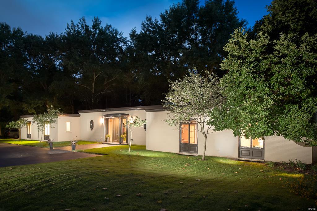 Contemporary living on 1.8 acres on a prestigious lane in Ladue. This home offers privacy and sophistication in a dramatic setting.  The foyer and living room feature marble flooring and dramatic 10 ft ceilings.  The kitchen has been updated with state of the art appliances, center island and abundance of cabinets.  The adjoining breakfast room is adjacent to the family room which provides as access to the patio and pool area. The master suite incorporates a luxurious bath, dressing area and huge walk-in closet and an adjoining office/study. Three additional bedrooms are spacious and have private baths. The lower level has been partially finished and includes a fitness area, recreational area, sitting area and bath.  All this and still plenty of storage. A virtual wall of windows provides beautiful views of the terrace, pool and garden.  Truly a hidden gem.