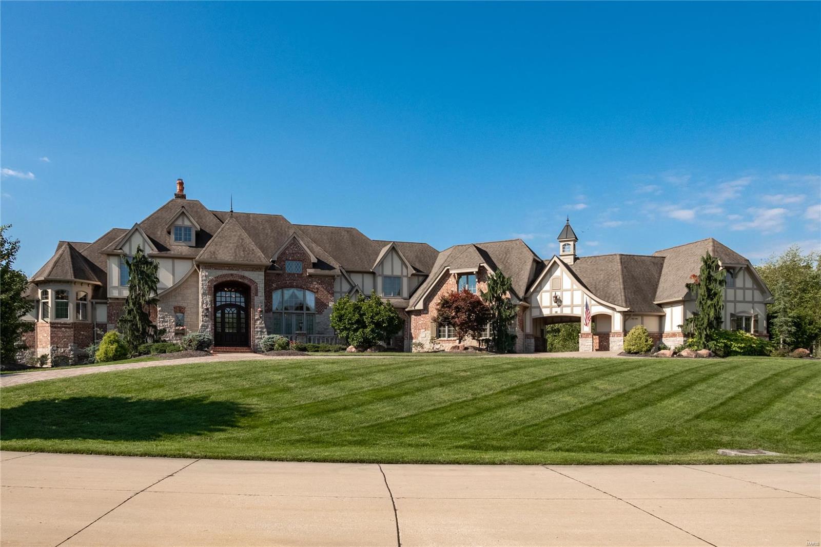 An impressive sense of arrival greets you at the gated entry, leads to a paved driveway and into the columned two-story foyer with marble flooring. Inspiring views of the majestic grounds are framed by the great room's expansive windows, exquisite millwork and 25 foot ceilings. Timeless and sophisticated appointments are accented by exotic wood flooring throughout.  A delightful kitchen offers a butler’s pantry, large island, state-of-the-art appliances and a windowed breakfast room, all of which connect with a warm hearth room and the tranquil outdoors. An elegant main floor primary suite features a paneled library, spa bathroom and French doors which open to the patios and pool.  Luxury amenities include an abundant in-law suite, elevator, game rooms, media room, wet bar, an oversized 5-bay garage with room for 6 cars, motor court, stone fountain, Koi pond, saltwater pool, pool house, stone patios, fire pit and curated landscape w/ mature plantings...all resting on 3 secluded acres!