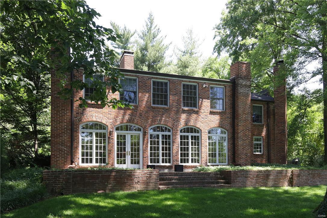 Ladue living at its best! This classically beautiful home features a formal living room and dining room opening into a spectacular sun room with multiple sets of french doors leading out to the expansive level 1.2 acre yard. Designed for today's living, the updated kitchen with center island opens to the breakfast area and fabulous family room with fireplace and built in bookcases and cabinets. Upstairs there is a large master with walk in closet, master bath with double sinks and separate tub and shower, and a small office space. There are also four other bedrooms, three additional baths and a cozy den with built in desk, built in bookcases and another fireplace. Tastefully decorated, this light filled and welcoming house is waiting for you! Additional Rooms: Sun Room