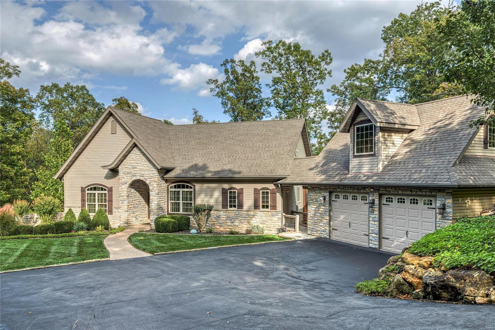 Beautiful LAKE ALPINE  home nestled on over 3 acres of woods for complete privacy, with a gentle, winding golf cart trail that leads to over 200' of waterfront & landscaped beach in a beautiful cove of Alpine. Open neutral space, wall of windows overlooking the grounds & lake, & spaciousness throughout. Perfect for entertaining w/gourmet kitchen, stainless appliances & room for gathering, inside & out on the deck, screened porch & waterside dock. The main level features a master suite, ensuite guest room, a library w/built in bookshelves and a Vermont soapstone wood-burning stove to keep you toasty on winter nights. The lower level has 2 more bedrooms w/water views, a rec area & entertainment kitchen, large workshop+storage. In addition this lot has 5 adjacent acres of common ground to enjoy the wildlife and seclusion. Additional Rooms: Mud Room