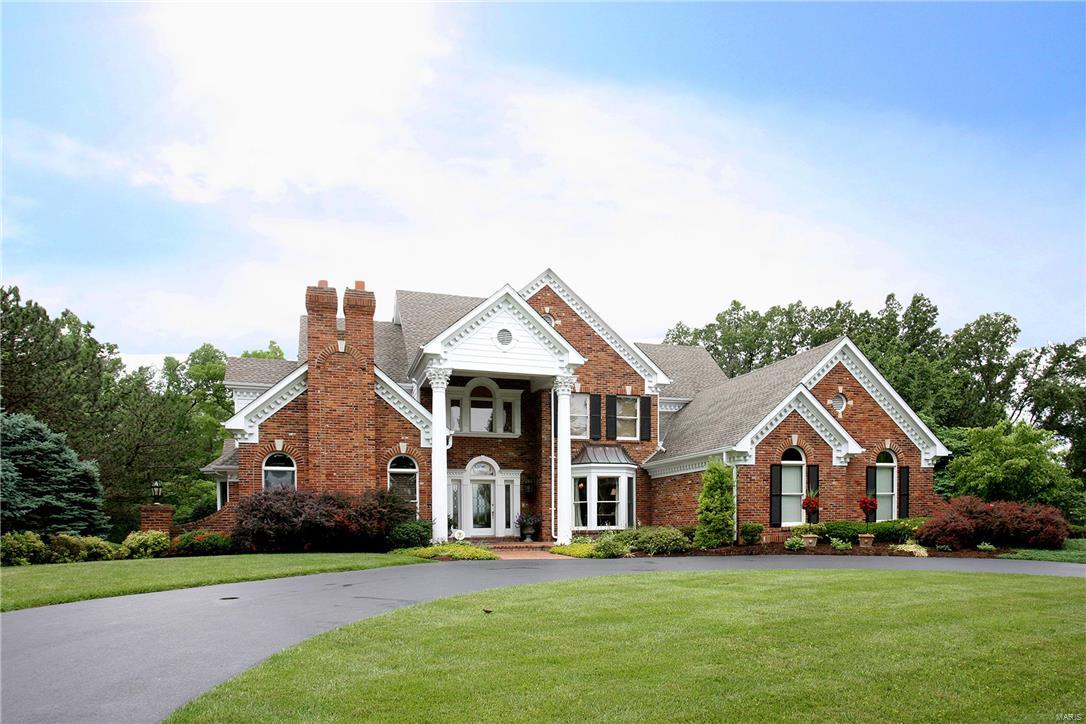 This classic masterpiece sits at the end of a 4 home cul-de-sac on a park-like 1 acre lot in Town and Country. The quality of millwork and amenities in this home are a rare find.  The two-story foyer boasts a grand curved staircase with intricate millwork, marble tile floor and opens to the oak paneled Office/Den with fireplace & built-in bookshelves, elegant dining room and dramatic step-down, two-story Great Room with French doors that open to the patio with outdoor fireplace and private salt water pool. Spacious Kitchen, custom white cabinets, top-of-the-line appliances, solid surface counter tops, center island, breakfast area and cozy hearth room.  First floor Master suite with vaulted ceiling and spa-like Master Bath, custom closet.  The upper level features 3 Bedrooms and 2 baths.  Lower level Family Room with fireplace, Exercise Room, Wine Cellar, Bath and tons of storage. Three car oversized garage, circular drive, newer roof. Mint condition...Don’t miss this incredible home!