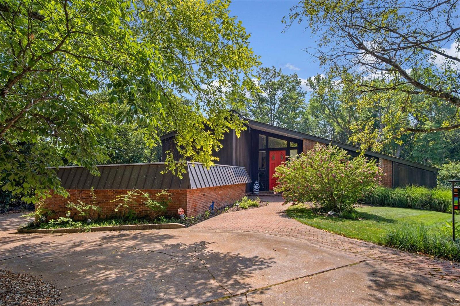 Nestled among mature landscaping, this sophisticated home is loaded w/special features. LR w/20 ft ceilings & wall of windows w/2 sets of sliders opens to a huge deck boasting Trex decking, outdoor TV, 2 commercial fans & a hot tub. Totally renovated in 2018, the sleek kitchen highlights incl. SS bkfst bar & integrated sink w/ touchless faucet, under-cabinet lighting, Brazilian Azul Macaubas quartzite & mother of pearl backsplash, high end SS appliances; & wet bar. Slider provides access to side patio w/raised planter boxes. Main floor primary suite w/wall of windows & 2 sliders opening to the back deck. Luxurious ensuite w/soaking tub, oversized shower, double vanity, & huge walk-in closet. Cozy FR, large DR adjacent to kitchen, spacious walk-in pantry,  laundry room, add’l BR & full BA round out main floor. Finished LL is entertainer’s dream w/wine storage, new carpet & flooring, updated wet bar, & 1/2 BA. Upstairs are 3 add’l BR & 2 BA, located off a “catwalk” overlooking the LR.