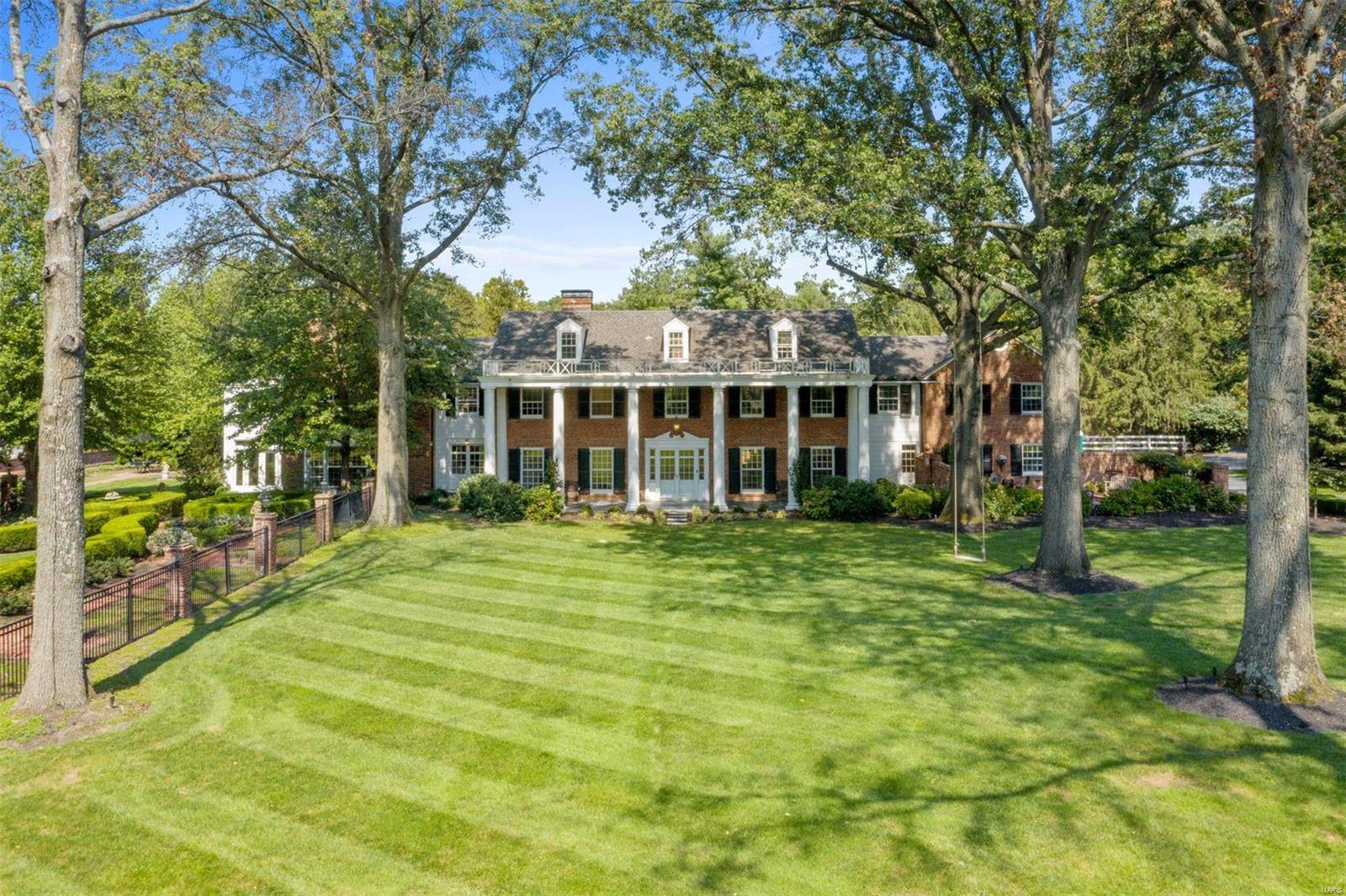 This impressive newly-renovated home sits on nearly 2 acres of park-like grounds in prime Ladue. Timeless architectural details combine beautifully with modern updates, including distinctive millwork and doors, herringbone floors, and a spectacular floating curved staircase. The superb kitchen boasts two islands, white marble countertops and slab backsplash, state-of-the-art appliances, wet bar, breakfast room, and adjoining family room with box-beam ceiling and fireplace. Upstairs, you will find an unparalleled Primary suite complete with a sitting room, office, private gym with wet bar, walk-in closet, and ensuite bath drenched in white marble. An additional 4 bedrooms, 3 full baths (2 ensuite and 1 jack-and-jill), laundry room, and bonus room complete the 2nd floor. Finished lower level with wine cellar and theatre room, saltwater pool, formal gardens, brick pathways, multiple patios and terraces, and an outdoor fireplace and grill. Attached 3 car garage and circle driveway. Additional Rooms: Sun Room, Wine Cellar