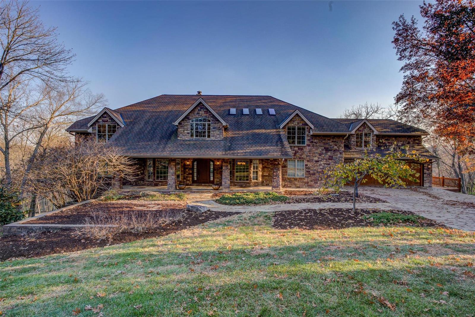 Fabulous sprawling 1.5 story nestled in a quiet cul-de-sac on 4.6+/- acres! Boasting a 4-car garage, 6 bedrooms, 6 full & 2 half baths. Enter through the gorgeous Mahogany wood front door and be amazed at the soaring vaulted ceiling, raised gas FP w/marble surround, Kempas wood flooring & abundance of natural light through the wall of windows in Living Room. Eat-in gourmet kitchen flaunts custom cabinets, granite counters, two islands, two built-in fridge/freezer's & two walk-outs. Main level owner's suite, features a large walk-in closet & lavish bath w/double sink vanity, steam shower, therapy tub, heated floors, & laundry room. Completing the main level are two office/sitting room’s, dining room, mud room, & screened-in porch. Upper level extends living quarters w/4 add'l bedrooms, large family room, bonus room, & add'l laundry room. Walk-out lower level boasts a large rec room with a raised stone floor-to-ceiling WB FP, full kitchen, movie room, bedroom, storage room, & workshop. Additional Rooms: Mud Room