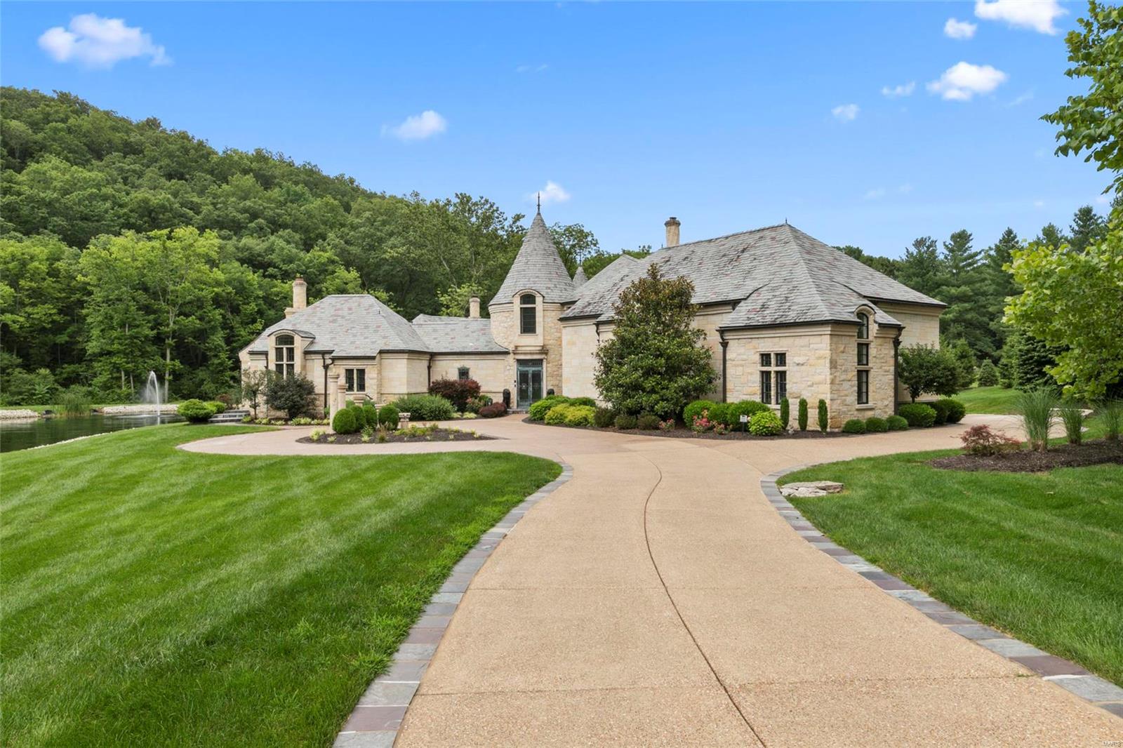 Breathtaking European Castle! 6 Bed, 9 Bath, 12,000+ sq ft of living space situated on 5.48 acres in gated community. Walk through bronze front doors & enter the 2 story foyer that leads to the great room w/fiber optic star lights and cherry hand laser cut ceiling as well as cherry & walnut dovetailed floors. Kitchen has custom cabinetry, multi level island, 2 sub zero fridges, wine fridge, 6 burner Wolf stove, 2 dishwashers, 2 sinks & walk in Butlers Pantry. Master Bedroom Suite includes triple layer custom crown molding with cherry wood ceiling & fiber optic star lights, Executive Office w/see through fireplace, His & Hers Closets, 2nd laundry room, Exercise Room, Master Bath w/His & Hers vanity, walk in shower w/LED Lighting & infinity tub. Finished LL includes 1000 bottle wine cellar, fireplace, half bath, & Bar. Theater Room w/seating for 7. Guest house has private entry w/full bath & kitchen. Stocked lake w/waterfall. Nearby St Albans featuring 2 world class 18 hole golf courses. Additional Rooms: Sun Room