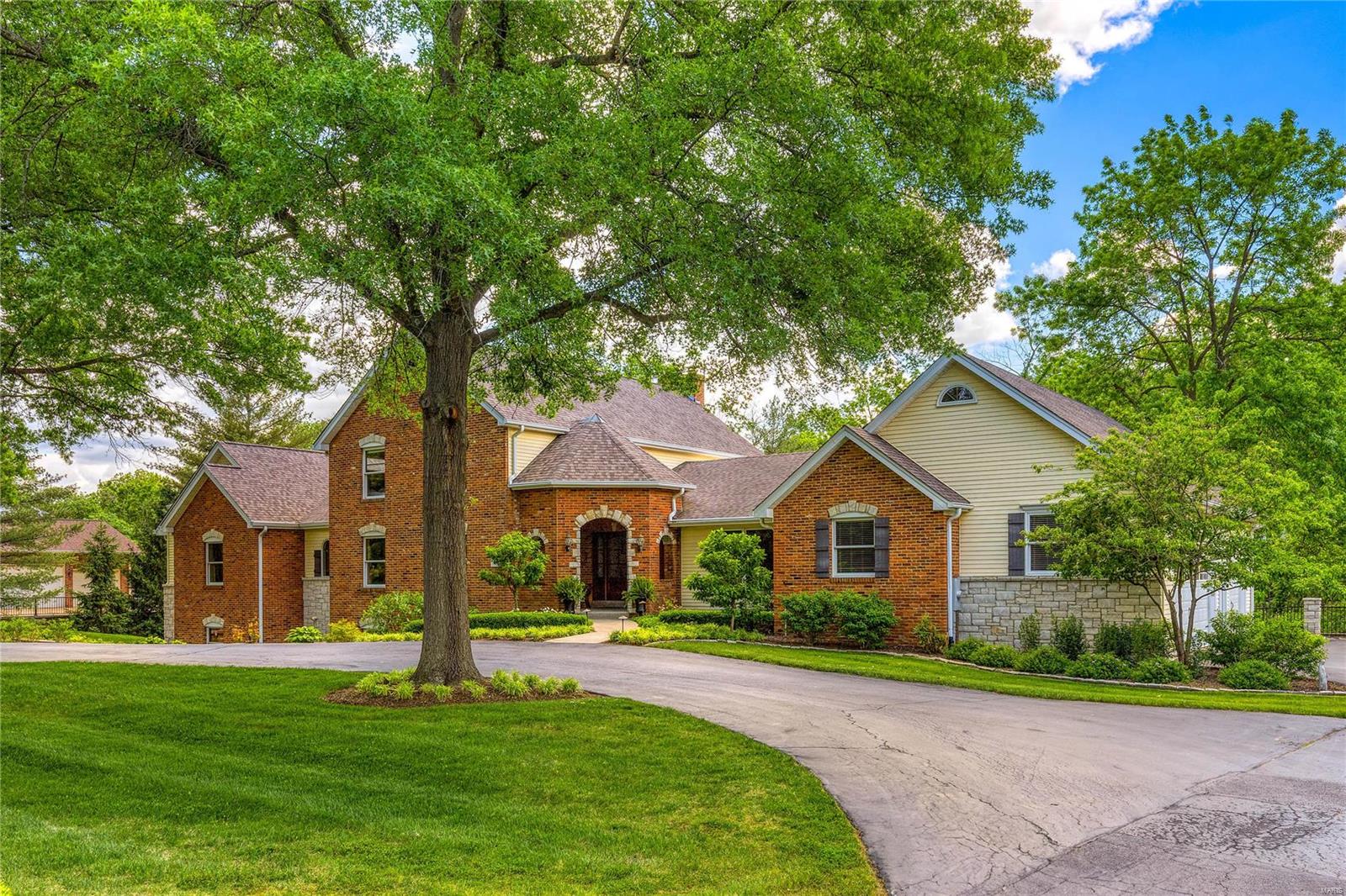 Spectacular brick & stone 1.5 Sty extensively renovated & expanded while maintaining the charm & character of the original architecture. Impressive hardwood foyer leads to private study with custom built-ins & fireplace, formal dining room & stunning 2-sty great room with beamed ceiling, floor-to-ceiling stone fireplace & sliding glass door that opens to screened porch. Vaulted kitchen with white cabinetry, quartz countertops, premium appliances, skylights & 7’ center island adjoins light-filled breakfast room with butler’s pantry & sunroom that overlooks wooded ground. Primary bedroom suite with luxury bath with jetted tub & sitting room offers an appealing retreat. The 2nd floor extends the living quarters with 2 additional bedrooms & hall full bath. Lower Level entertainment space includes recreation room, game room with brick fireplace & 2nd kitchen plus workout room, 4th & 5th bedrooms & 2 full baths. Situated on a .89-acre lot with pool, deck, covered patio & 2 screened porches. Additional Rooms: Sun Room