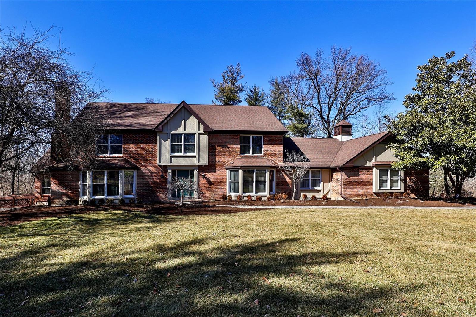 Lovely  Tudor home  on 3 wooded acres . Expansive  open floor plan lends itself to entertaining.  Center hall entry with large living room and dining room on either side. Beamed family room is spacious and yet cozy and opens to a lovely garden room. Sizable   eat in kitchen with granite counters and stainless appliances. Main floor bedroom could also be a perfect home office. Front and back staircases lead you to the Master suite along with 3 other bedrooms and a full bath. Lower level offers you yet another bedroom with new full bath . A second family room and large exercise room complete this level. 
In ground pool, patio, 3 car garage... this home offers the whole package. Plus convenient to highway , restaurants and shopping!