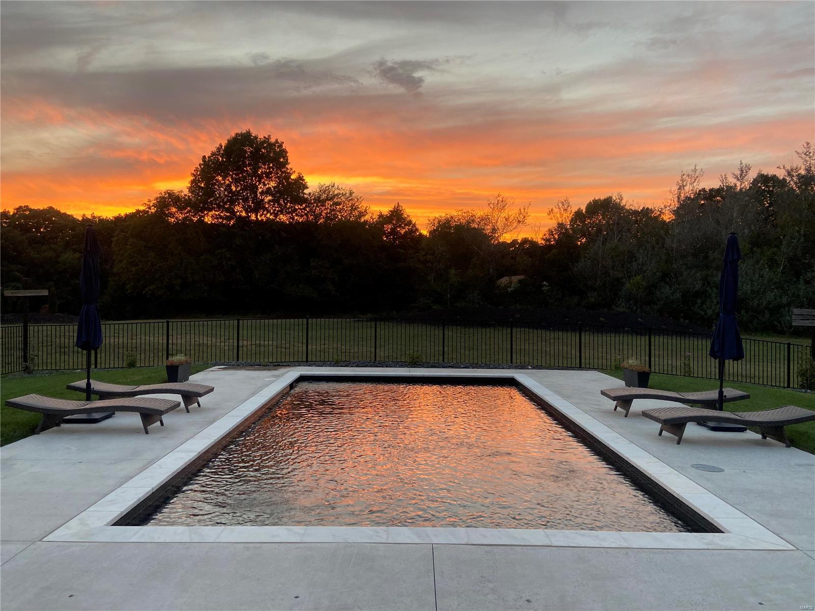JAMES HARDIE SIDING & ANDERSON windows.This CUSTOM home is sitting on 3 PRIVATE ACRES in the Francis Howell School District, A FULL IN-LAW QUARTERS w/ OWN ENTRY & COMPOSTE DECK, QUARTZ COUNTERS & even it's own laundry!
The PEBBLETEC POOL was completed in 2023 w/ HEATER, CHILLER, LAMINAR FOUNTAIN JETS & the latest in technology all can be controlled w/ app. There is a large, COVERED PATIO w/ great entertainment space, IRRIGATION SYSTEM, WATER SOFTNER, HEAT PUMP, OVERSIZED 5 CAR GARAGE w/ half bath also ACCESSED from pool. The Gourmet Kitchen is a Chefs dream w/ 2 large WALK-IN PANTRIES, SPICE DRAWER, QUARTZ WATERFALL ISLAND & BACKSPLASH, DOUBLE OVENS, an IN-ISLAND MICROWAVE & of course GAS range. Off the kitchen, a full WET BAR w/ QUARTZ COUNTER & BACKSPLASH, BEVERAGE FRIDGE & ICEMAKER. ALL cabinets offer ROLL OUTS & DOVETAIL. 4 bdrms have OWN BATH each w/ QUARTZ COUNTERS, TILE SURROUND & WALK-IN CLOSETS. The LL features  QUARTZ WET BAR, THEATER w/ SURROUND, WORKOUT rm, REC rm & More. Additional Rooms: Mud Room