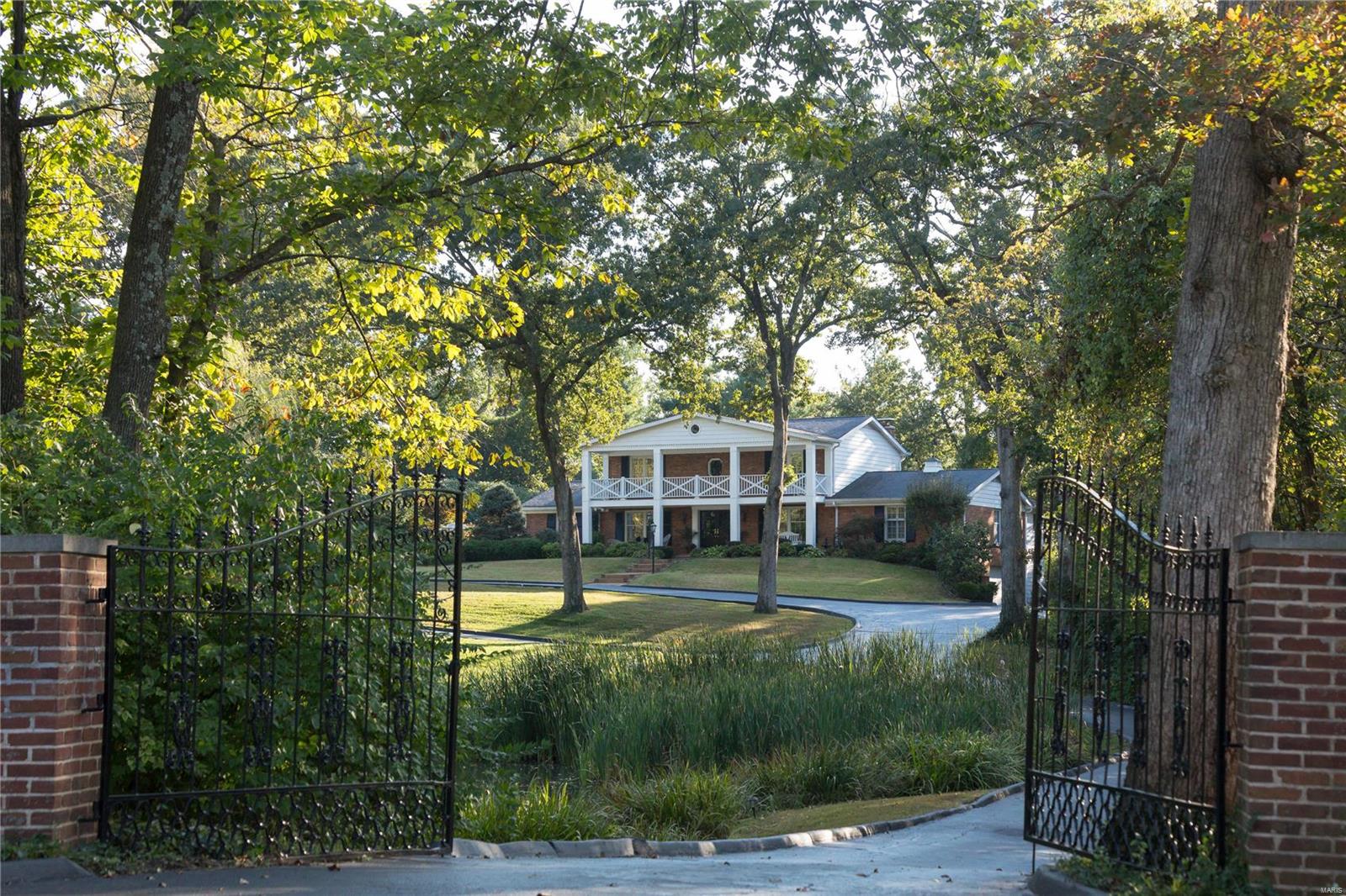 A country lifestyle on 3 rolling acres in centrally located Village of Huntleigh. A long gated drive leads to a gracious 2-story Southern Colonial home with pool, comprised of 5,000+ square feet of living space with 5 bedrooms and 5 baths. A hearth room addition features coffered ceiling, wet bar, fireplace and herringbone floors. The updated kitchen and breakfast room overlook saltwater pool and patio. Wolf, Viking, SubZero, and Bosch appliances. Main level master suite with walk-in closet and luxe bath. 2nd level hosts 4 bedrooms and 2 full baths. Two bedrooms open to the portico's balcony. Finished Lower level with card and billiard areas, complete with sauna and full bath. 3 Car garage. Private pond attracts heron, geese, and other wildlife for a parklike setting. Lighted tennis court, conveyed as-is; refurbish or transform turned into sport court, pool house or Barn, as property is Equestrian. Adjacent to Plaza Frontenac, restaurants, shops and the new Lifestyle Center.