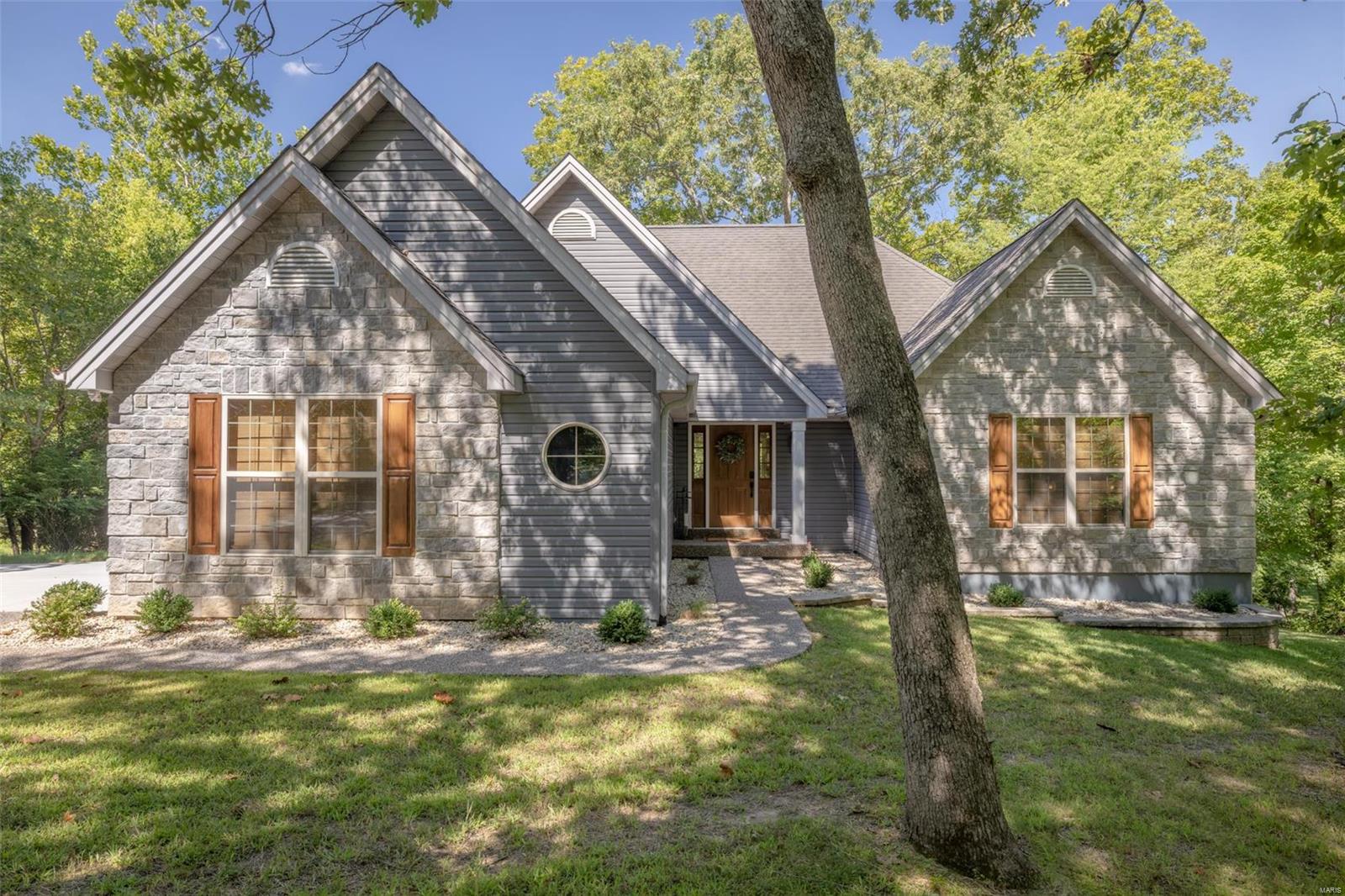 Exquisitely remodeled from top to bottom. Turn Key Professionally decorated includes most  furnishings. See attached Exclusion List
Space, sophistication, and – best of all- stunning lake views are all yours at this spectacular Lakefront home on sought after Lake Charrette. Bring the whole crew and live comfortably with four roomy bedrooms, and adorable bunk room, three beautifully remodeled full baths and many stylish hangout spaces indoors and out.  Stunning remodeled kitchen opens to the large great room with stone fireplace and a huge wall of windows. Off the great room is an expansive upper level deck perfect for lounging around the gas firepit and enjoying the views.  The lower level boasts a fabulous rec room that comes equipped with pinball games and arcade games all walking out to a large patio area. Gentle slope to adorable fire pit area and private lakeside dock.