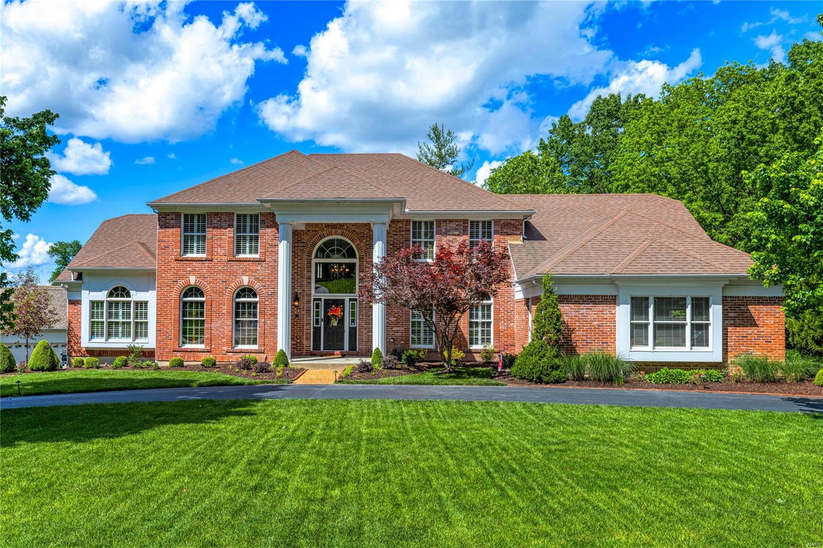 This exceptional Mayer showcase home features well-proportioned rooms with oak hardwoods, soaring ceilings, detailed trim work & plantation shutters. Impressive 2-sty foyer leads to library-paneled study with built-in bookcases, formal dining room & stunning great room with floor-to-ceiling brick fireplace & 2-sty windows with private wooded views. Designer kitchen with glazed cabinetry, granite countertops, KitchenAid appliances & 8’ center island adjoins breakfast room with convenient planning center & pass-through bar. Vaulted primary bedroom suite with marble bath offers an appealing retreat. T-staircase accesses 3 additional bedrooms, 1 with ensuite bath, hall full bath & bonus loft room. Lower Level entertainment space includes recreation room with stacked stone fireplace, game room, gathering bar, office, workout room & full bath. Premium .54-acre cul-de-sac lot with hot tub, deck, covered patio & flagstone patio with firepit & fountain. Tennis courts & pool are just steps away.