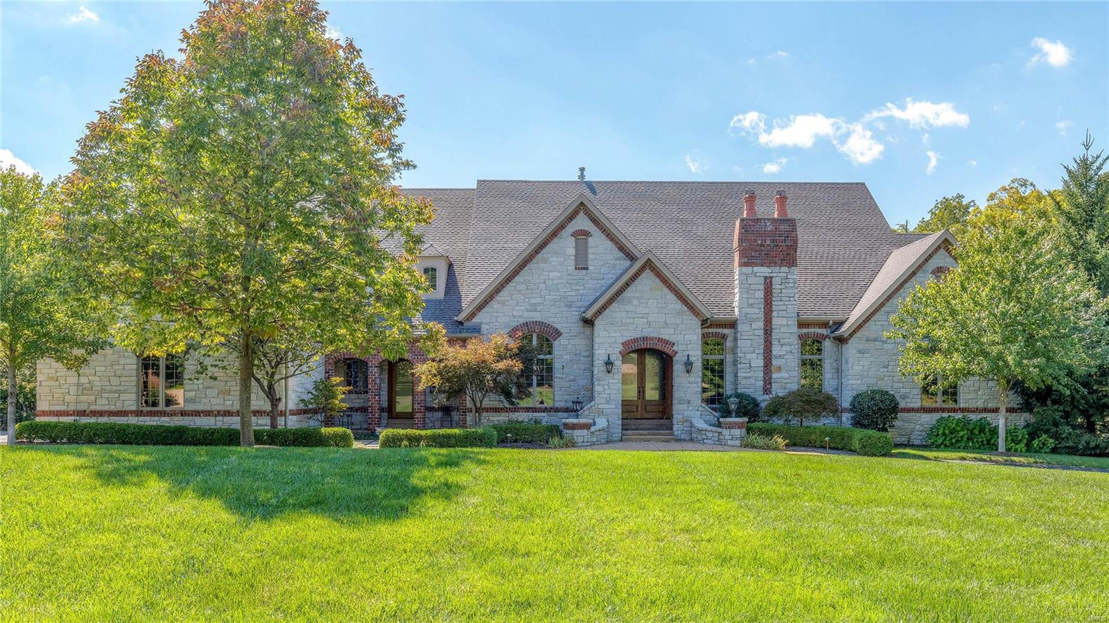 Magnificent European-inspired Estate home! DeShetler-built 1-sty with over 7200 sf of living space enhanced by wide plank oak flooring, exquisite moldings, 12’ ceilings & arched entryways. Expansive marble foyer leads to private study surrounded by natural oak paneling & bookcases, elegant dining room & stunning great room with beamed cathedral ceiling & marble fireplace. Chef’s kitchen featuring cherry cabinetry, commercial grade appliances, butler’s pantry & convenient planning center adjoins sunlit breakfast room, hearth room with floor-to-ceiling stone fireplace & gathering bar. Coffered master bedroom suite with marble fireplace, walk-in closet with 2nd laundry & lavish bath with shower spa & jetted tub plus 2 additional bedroom suites complete the main floor living quarters. Lower Level includes recreation room with wet bar, game room, workout room, 4th & 5th bedrooms with Jack n’ Jill bath & ½ bath. Situated on an extensively landscaped 1.8- ac lot with 3 patios & 4-car garage.