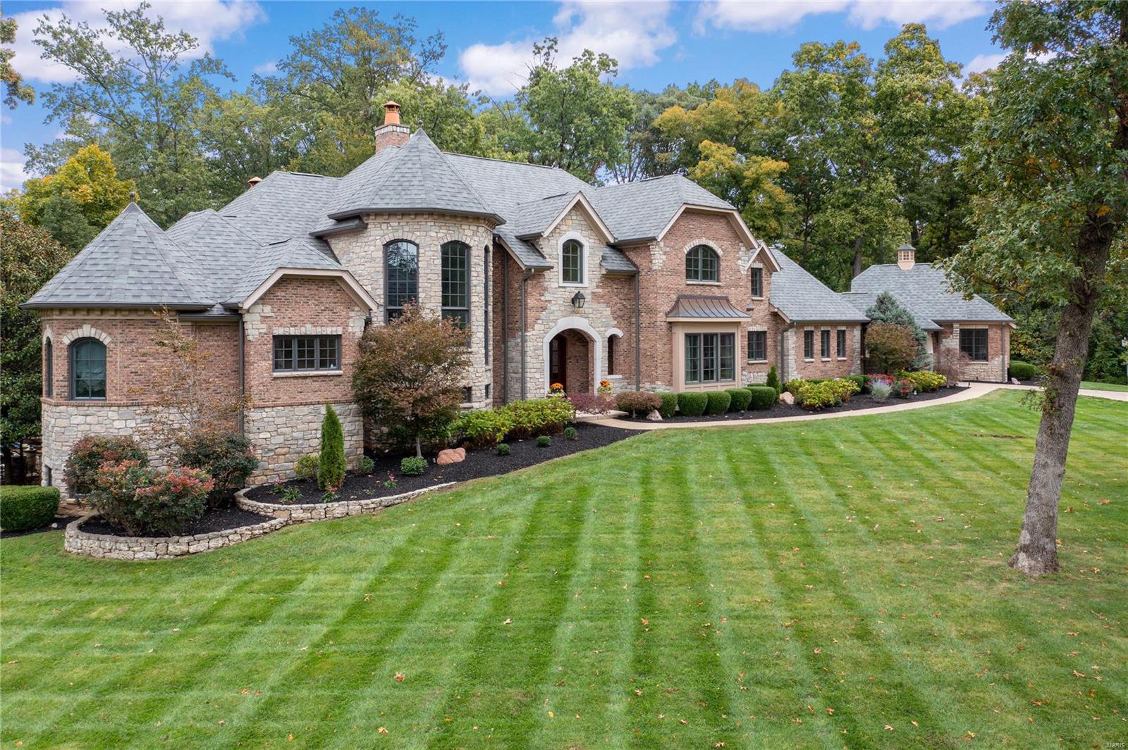 The epitome of luxury living, this custom 1.5 story home, features over 9000 SF of stunning living space. Traditional in design, it delivers the ultimate in casual elegance. Exquisite mill work, soaring ceilings & 5 unique fireplaces, it has it all. The stately 
foyer leads to a 2 story living room, formal dining & private paneled office. The 1st flr primary suite includes His/Her walk in closets, gas fireplace, luxury bath, walk in shower, spa tub & double vanities. The epicurean kitchen, expansive hearth room & open breakfast area are surrounded by windows.  Alluring alfresco spaces include the idyllic outdoor kitchen, & covered patio overlooking the custom pool, spa & waterfall.  A grand staircase leads to 3 spacious en suite bedrooms & loft. The entertainment extravaganza continues in the lower level with an expansive bar, media room, gym, & billiards. PLUS, a 5th bedroom, full bath & wine closet. Porte cochere connects the 2 garages/4spaces. It's architecturally delightful!
 
. Additional Rooms: Mud Room, Wine Cellar