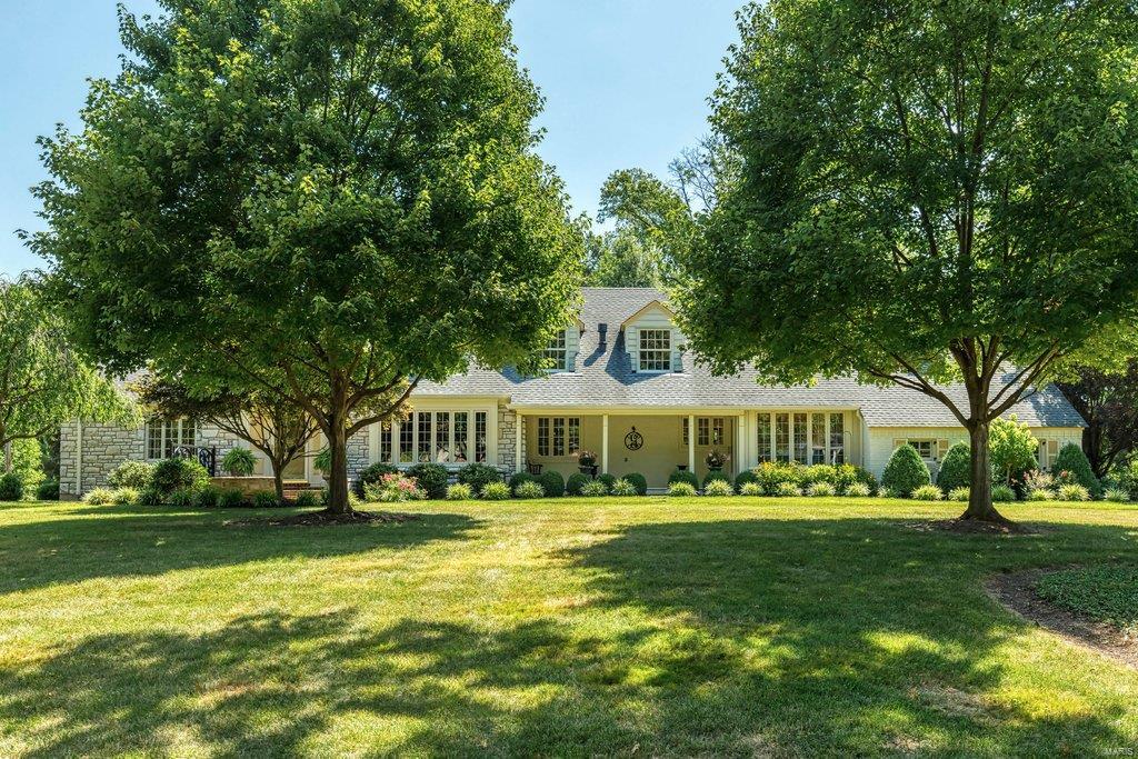 Picture perfect Cape Cod. Located in one of Frontenac’s most desirable neighborhoods. Gracious slate entry foyer leads to formal living room highlighted by marble fireplace, elegant dining room and spacious family room. Chef’s kitchen with 42” white cabinetry, Corian countertops, premium appliances & center island adjoins light-filled breakfast room with butler’s pantry and hearth room with beamed cathedral ceiling, brick fireplace & sliding glass door that opens to tiled porch. A large bedroom & hall full bath complete the main floor living quarters. Oak staircase accesses master bedroom suite with brick fireplace, customized walk-in closet & luxury bath with His & Hers vanities & shower spa plus 2 generous-sized additional bedrooms with Jack & Jill bath & sitting room. Walk-out Lower Level is ideal for casual entertaining with recreation room & half bath. Situated on a parklike 1+ acre lot with paver patio surrounded by landscaped gardens. Award-winning Ladue School district.
