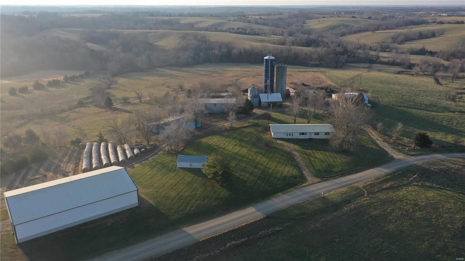 Encompassing 438 contiguous acres in Linn County, Missouri, this well-manicured combo farm is a rare find these days.  Currently in hay production, approximately 368 acres are open & could be easily converted to tillable cropland. 70 acres of timber and 8 ponds provide lots of hunting and fishing opportunities. Numerous buildings on site including: 54x84 Morton bldg., 30x60 machine shed, 2 grain bins & silo. There is also an 1800 sq. ft. ranch home in need of a little TLC. Picturesque views and  excellent access with county roads on all sides.