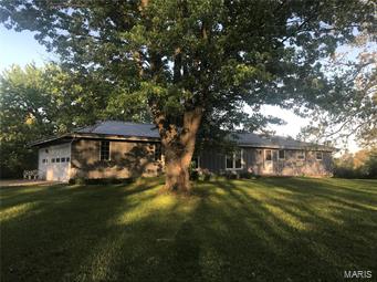 392 ACRE FARM about 4 mi N of St. James in the beautiful Ozark Foothills with 1240' hwy frontage & 1/2 mi county road frontage, fenced, cross fenced, lots of gates & equipment trails, bottom crop land, pasture & hay with a good mix of about half woods.  Coppedge Creek meanders through the whole farm for year round water.  Older but sizable outbuildings provide plenty of storage & cover for hay, equipment, livestock & toys.  Asphalt driveway winds from highway to custom built 3BR, 2 1/2 bath spacious ranch home with thermal windows, central HVAC, beautiful pegged oak plank hardwood flooring, family room with Pyro FP & sunroom with scenic view of gently rolling pasture with forest line beyond.  Home has a Murdon septic with aeriator  & deep well.  A second deep well on property could furnish additional homesite. GREAT CATTLE/ CROP FARM AND A HUNTER'S PARADISE IN AN EXCELLENT LOCATION BETWEEN ST. LOUIS & SPRINGFIELD.  Call today to schedule your tour. Aerial Video of farm in Adv Remarks.