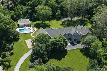 Outstanding 17 year old custom home on 2.84 landscaped acres in the heart of Ladue. The owner’s attention to detail is evident throughout, this 6+ bedroom, 11,700+ sq. ft. home.  A two story entrance hall with floating wrought iron staircase opens to a soaring living room and formal dining room. The library with cypress paneling and arched bookcases leads to the large master suite with luxury bath, his/her closets & sitting room. Loggia with 2 sets of French doors spans the back of the house leading to a bar area, butler’s pantry and top of the line kitchen /hearth room. Main floor laundry, mudroom, screened porch, additional bedroom & full bath.   Upstairs are 4 bedroom en suites, fabulous playroom, & another  en suite bedroom on 3rd floor. Lower level w/ media room, exercise room, wine cellar and ample storage.  Pool house w/ kitchen & full bath, heated pool, 4 car oversized garage, 3 fireplaces, large patio, tennis ct. and so much more! Additional Rooms: Mud Room