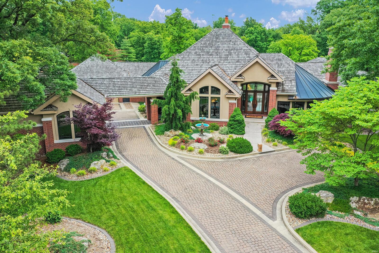 Enjoy life in the esteemed Stonebridge community of Edwardsville. This home is more than bricks…it’s a complete lifestyle catering to any mood you’re feeling. Like to entertain? Imagine hosting a corporate retreat or your friends and family YEAR-ROUND! Outdoors you’ll enjoy an amazing pool with large swim-up bar, outdoor grill area and a pool house with kitchen, bedroom, shower, and bathroom. There’s a hilltop retreat that’s perfect for enjoying a roaring fire while sitting around chatting and enjoying nature, all with the convenience of a restroom. Indoor entertaining is made easy, whether enjoying a gourmet meal in the formal dining room, enjoying cocktails at the FULL bar, enjoying a movie in the theater room and more. In the mood for some quiet time? Take a walk across the beautifully manicured landscaping enjoying the wildlife or step inside and relax in the sauna.This exquisite home has far too many luxuries to list…view details in the photo lineup or ask an agent for a full list Additional Rooms: Wine Cellar