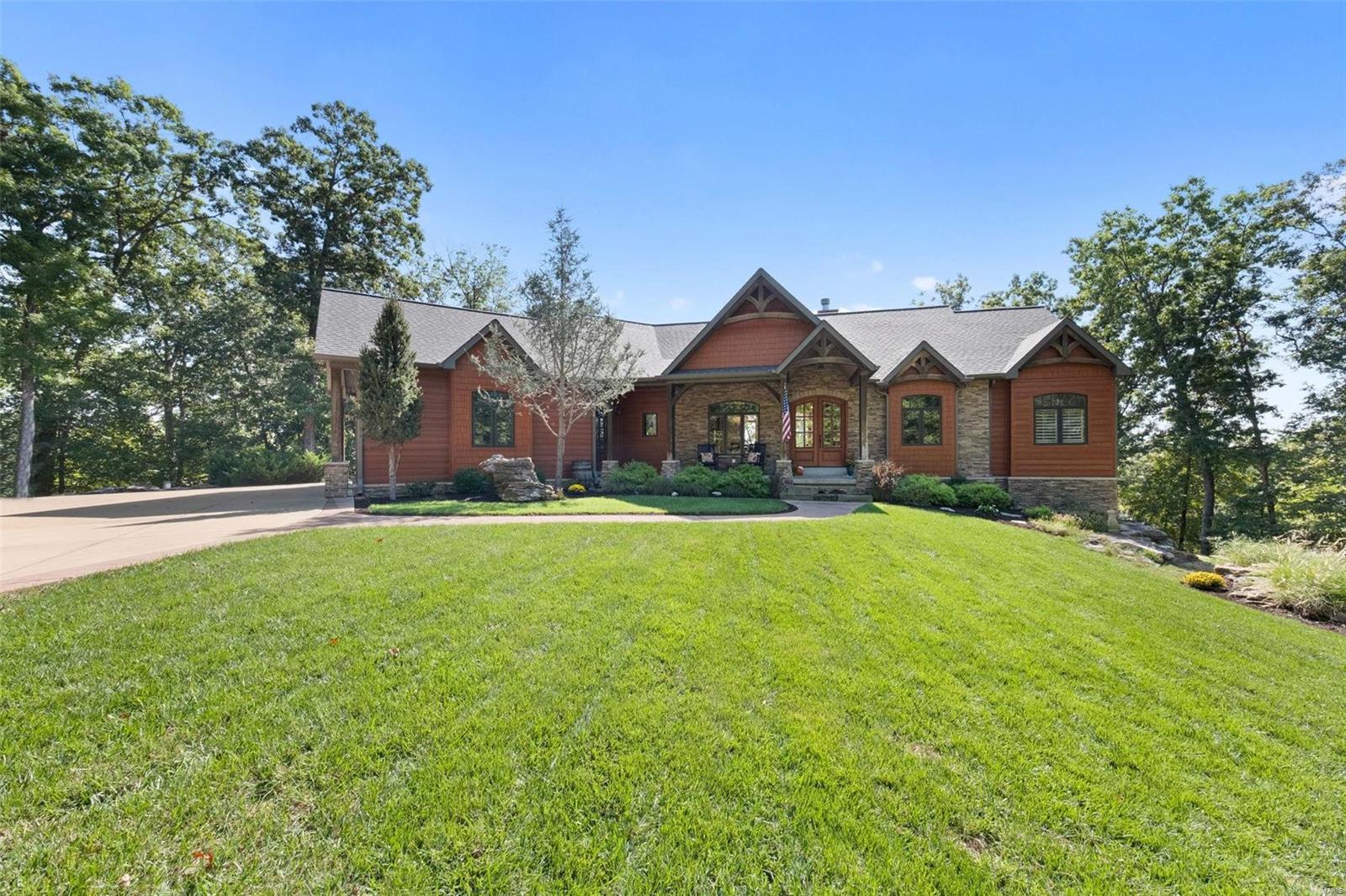 Secluded hilltop chalet on 22 acres in Wildwood! Minutes from hwy 44 & shopping. Experience the artful, rugged beauty of this stunning partial timber-frame home. Inside you’re greeted by soaring exposed timber ceilings, expansive views & natural light. Main floor features: 3/4" hickory floors, dining, den, breakfast rm, sitting rm, & gorgeous great rm w/ custom flr to ceiling stone fireplace. Split floor plan separates the primary suite from the private-entry guest wing. Primary suite: Walk in closets, custom bath, private deck w/ hot-tub.Thoughtfully designed kitchen: chef’s delight w/ commercial grade range/hood, ample cabinets & granite counters. 2 add. bedrms in the walkout LL along w/ a full bath, kitchenette, & 2 expansive living spaces. Designed to seamlessly blend indoor & outdoor living. Serene outdoor spaces w/ covered dining al fresco and stone fireplace, covered patio, fire-pit. Creek on property Constructed w/“SIP” panels for ultimate energy efficiency-Wired for generator.