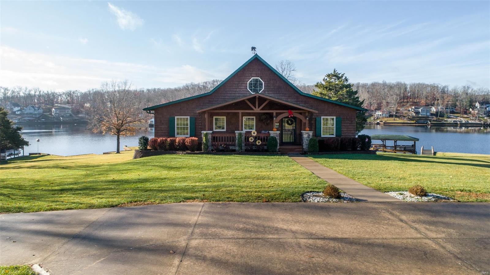 When it comes to Lake Perry properties this is one you don't want to miss! This property is
being offered fully furnished and is ready to enjoy for weekend getaways or year-round living with
the lake experience as everyday life. Boasting 3 bedrooms 4-1/2 baths, gourmet kitchen, and
a massive floor-to-ceiling wood burning fireplace in the great room for those long winter nights.
The lower level does not disappoint, offering a large rec room for pool, darts, poker or watching
the game with friends and family. This property sits on 2+ ac. of arguably the best views and
lakefront Lake Perry has to offer. As you tour the grounds you will see a covered boat slip/lift,
your own beach, your own private boat ramp, and two separate boat/kayak/canoe harbors. Wind
your day down sitting on the large deck overlooking the lake with a beverage of choice or BBQ
with friends in the pavilion. This is not a property you want to miss out on.
Schedule your appointment today, and come take a look!