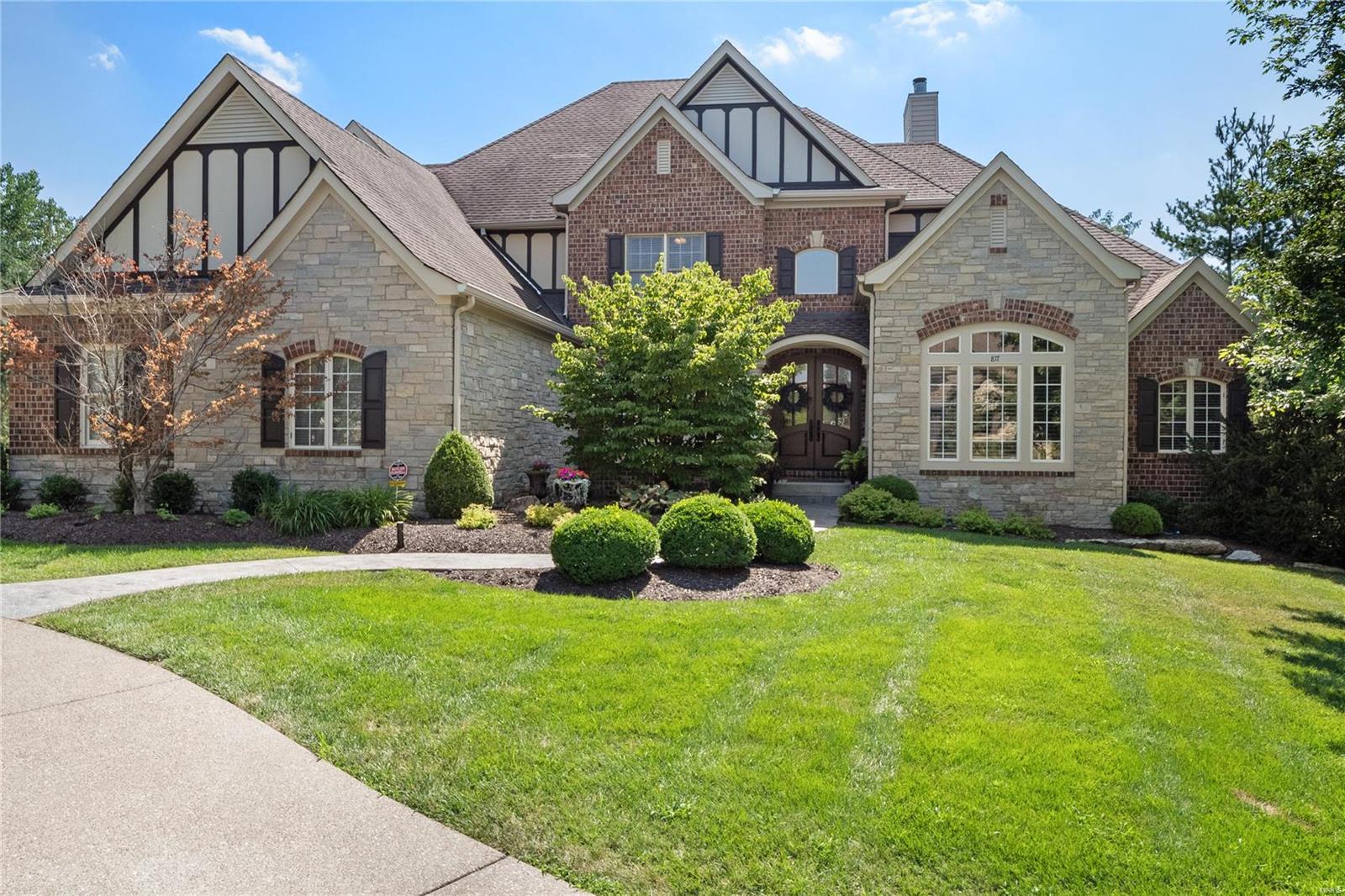 A gorgeous 6 bedroom estate located on a quiet cul-de-sac of 8 custom built homes. This stunner has a 3/4 acre lot and backs to trees! Room for all with over 5010+ sq ft on the upper levels + an additional 1900+ sq ft of finished lower level. You will be wowed as you enter the 2 story grand entry and notice the exquisite moldings, finishes and rich wood flooring extending throughout the main floor living areas. There is an impressive "Library" with extensive built-ins, a rolling library ladder, coffered ceiling, fireplace, bar and wall of windows. You will LOVE the recently redesigned kitchen & Hearth room. The large owners suite has a private office and the upper level has 4 bedrooms plus 3 baths. The walkout lower level has a huge family/game area plus a bar with full kitchen. There is another bedroom, a full bath, exercise area, another laundry area. Saved the best for last - HUGE screened porch w/wrap around deck, stone steps, huge salt water pool/spa, bar, large level play area+++