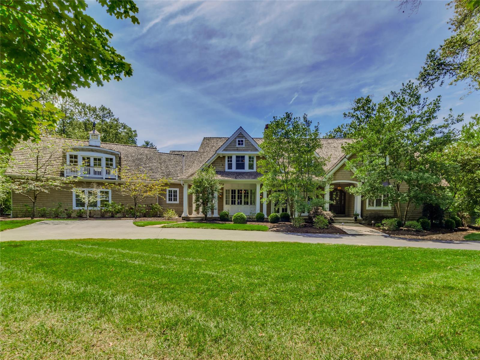 This beautifully crafted custom estate on 3 rolling acres in Ladue is reminiscent of a grand coastal home. This 12 year old home has amazing architectural details with reclaimed wide plank wood floors & beams, coffered & vaulted ceilings, stone fireplaces & stunning millwork. Gourmet kitchen with custom cabinetry, double island & French doors to deck overlooking the pool & sweeping grounds. The main floor luxury Master Suite features a fireplace, private balcony & sleek bath. Four additional suites on the 2nd floor plus an oversized bonus room & charming reading nook with a kids’ slide to the 1st floor! Enjoy entertaining in the walkout finished lower level with fireplace, rec room, bar area, exercise room & 2 full baths. The new pool house has a superb outdoor kitchen, entertaining area & additional 2 car garage. Don’t miss the huge basement sports area below the pool house. This special property features a total of 5 bedrooms, 7 full & 3 half baths, 7 fireplaces, & 5 garage spaces. Additional Rooms: Mud Room