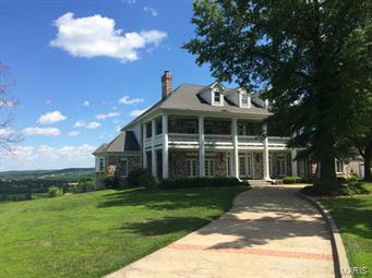 Approaching this stately home will take your breath away & the views are even better! Enjoy spectacular sunrises & observe Bald Eagles soaring over the river, while you relax in the cozy sunrm w/ a cup of coffee or on the deck w/ a glass of wine. This peaceful Wildwood retreat is a spacious 10,000 sqft, 1½ story, southern plantation style home sitting majestically on the Meramec River Valley Bluffs. 2 story entry w/ winding staircase leads to the great rm w/ palladian windows. Cstm kitchen w/ double-ovens, warming drwer, brkfst bar, 42” cabinets, hard wood floors, huge wlk-in pntry. Luxurious ML master suite feat. huge custom closet. 4 large UL bdrms w/ Jack & Jill baths. 3rd level boasts HUGE bonus rm w/ full bth. Finished walk-out LL feat. see-thru FP & cstm bar. 2 stories of wrap around porches, beautiful stamped concrete driveways, decks, patios & porches. Construction quality second to none, inc. extensive millwork, cstm closets, high ceilings & abundant architectural details.